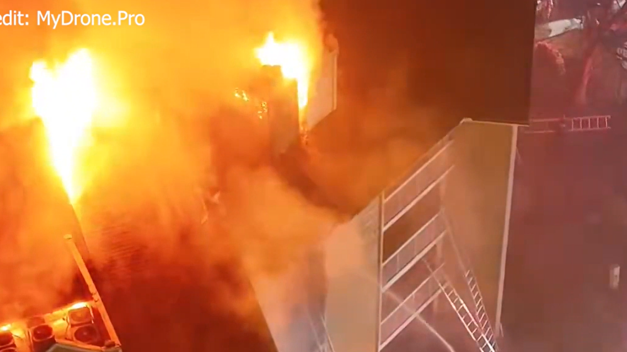 1 rescued as fire crews battle massive blaze at apartment building in ...