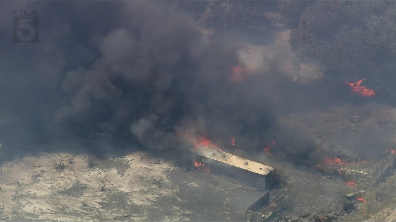 Crews battle brush fire burning structures in Riverside County - AOL