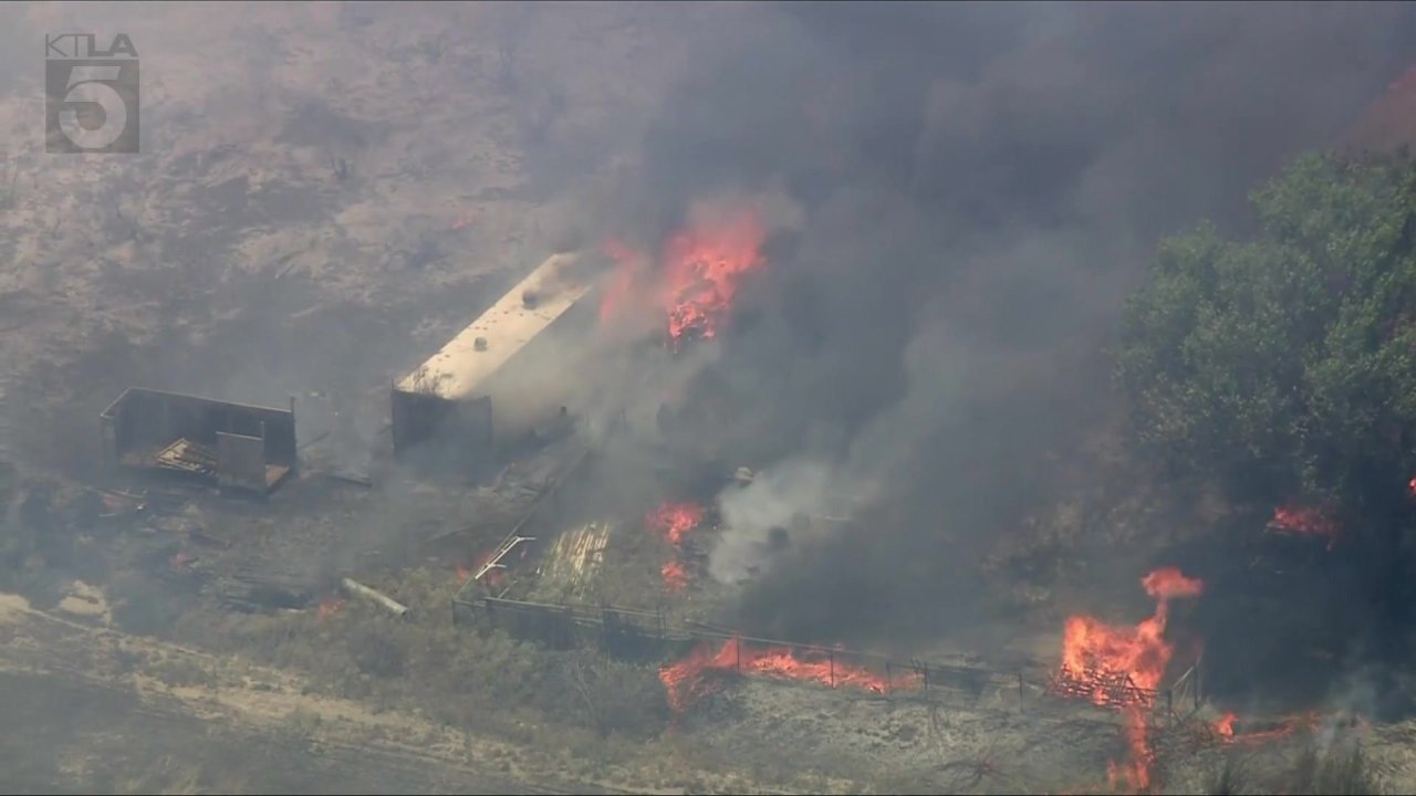 Crews battle brush fire burning structures in Riverside County - AOL