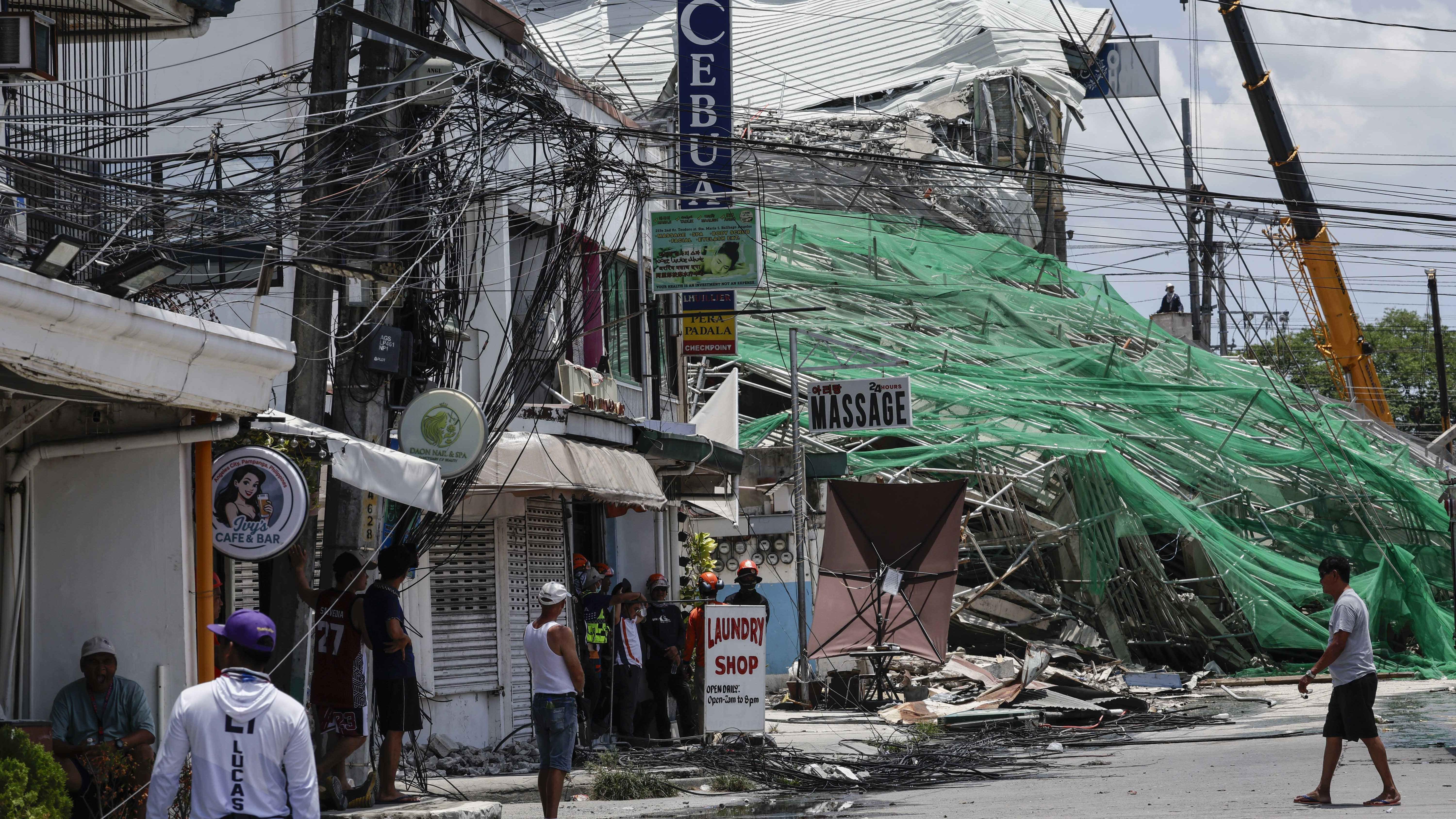 One killed and many feared trapped under collapsed building in ...