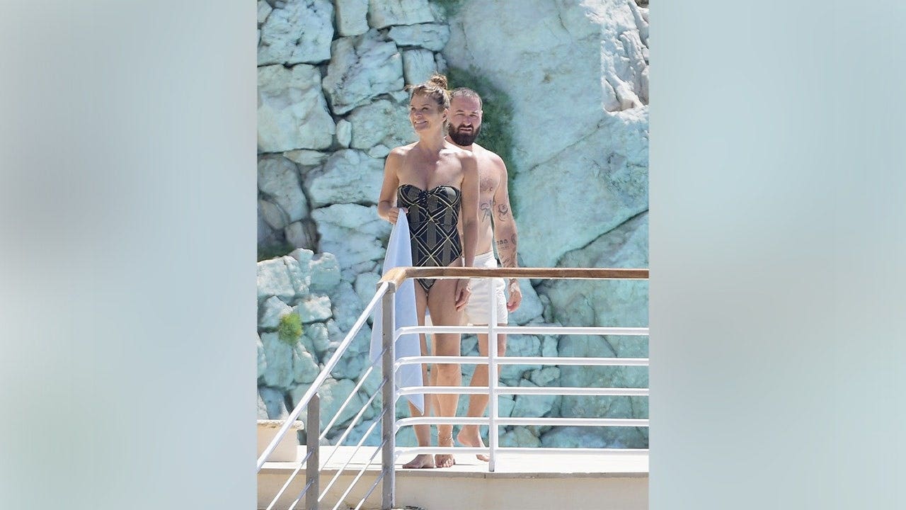 Helena Christensen soaks up the sun in strapless swimsuit after