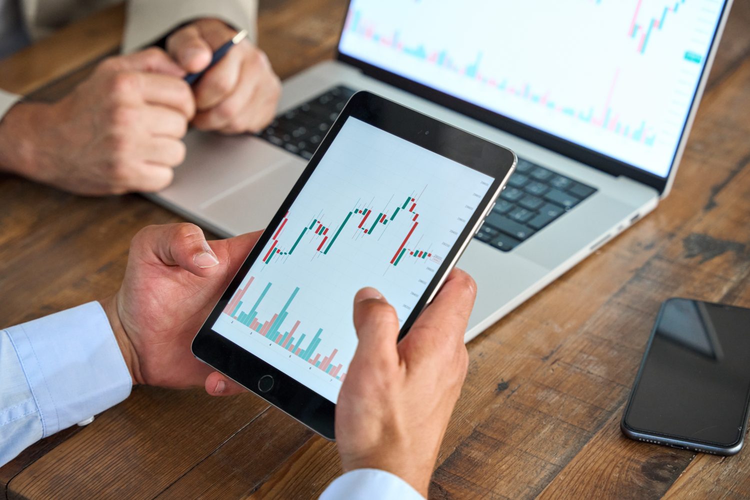 Business analyst, financial advisor or crypto trader holding digital tablet in hands consulting stock market investor analyzing trade charts dynamic indexes investing trends on tab screen. Close up.