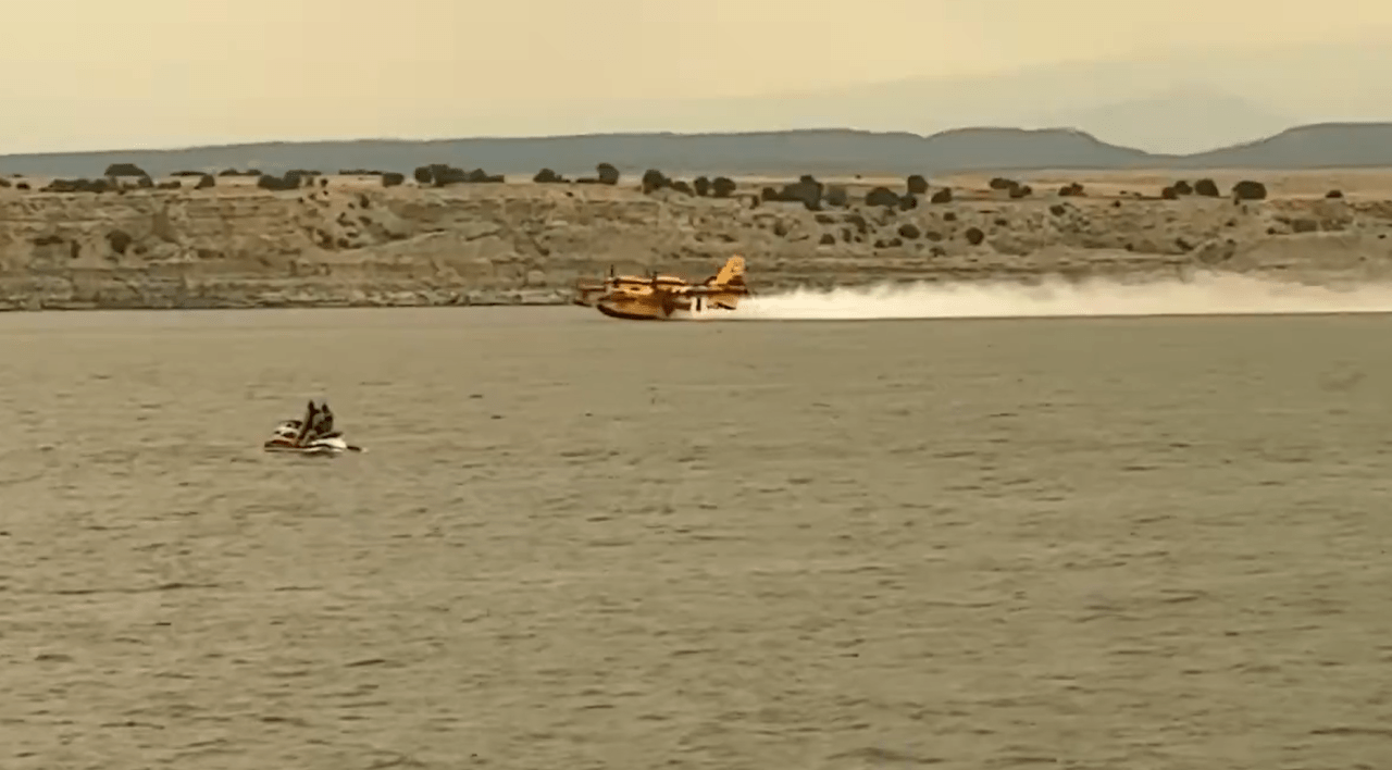 Fire response aircraft gathering water from Lake Pueblo to fight Aspen Acres fire