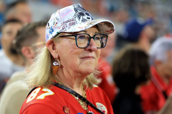 An older woman with glasses and a hat