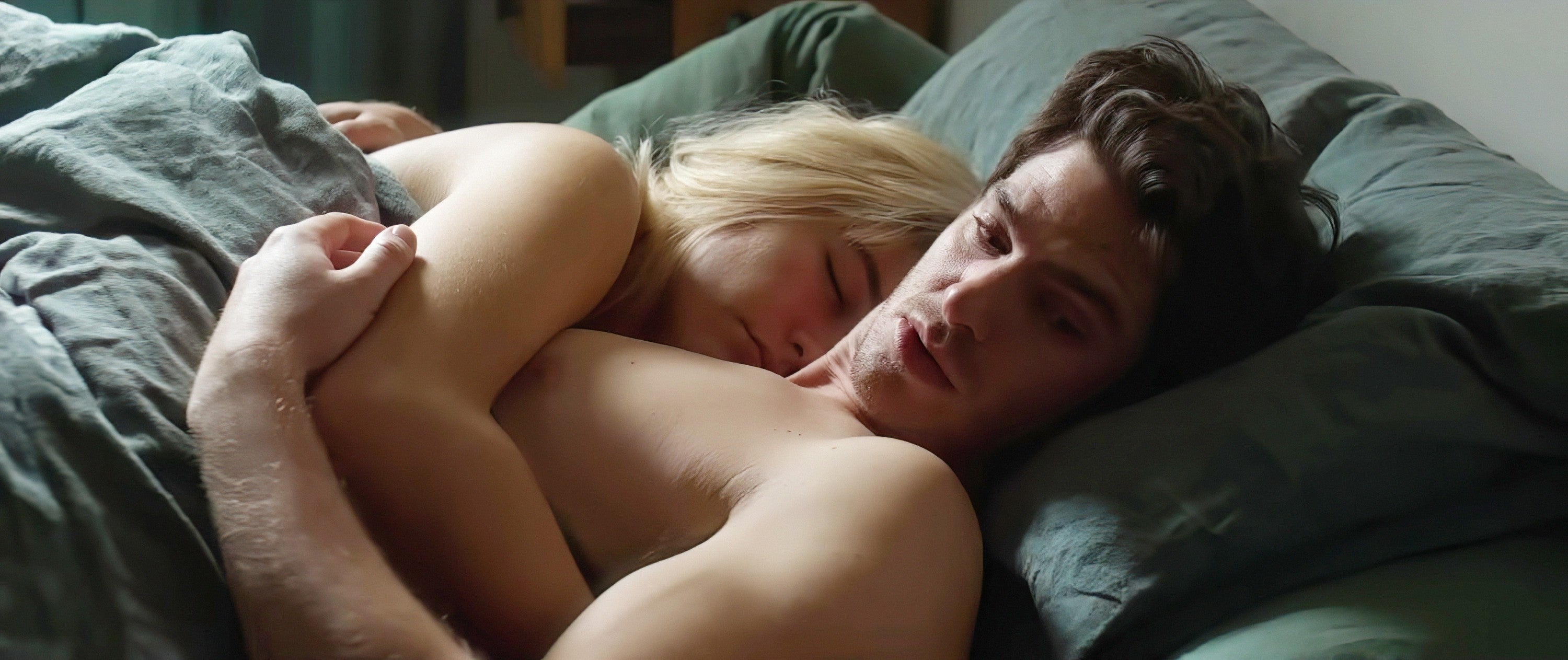 Florence Pugh and Andrew Garfield cuddling and lying shirtless in bed