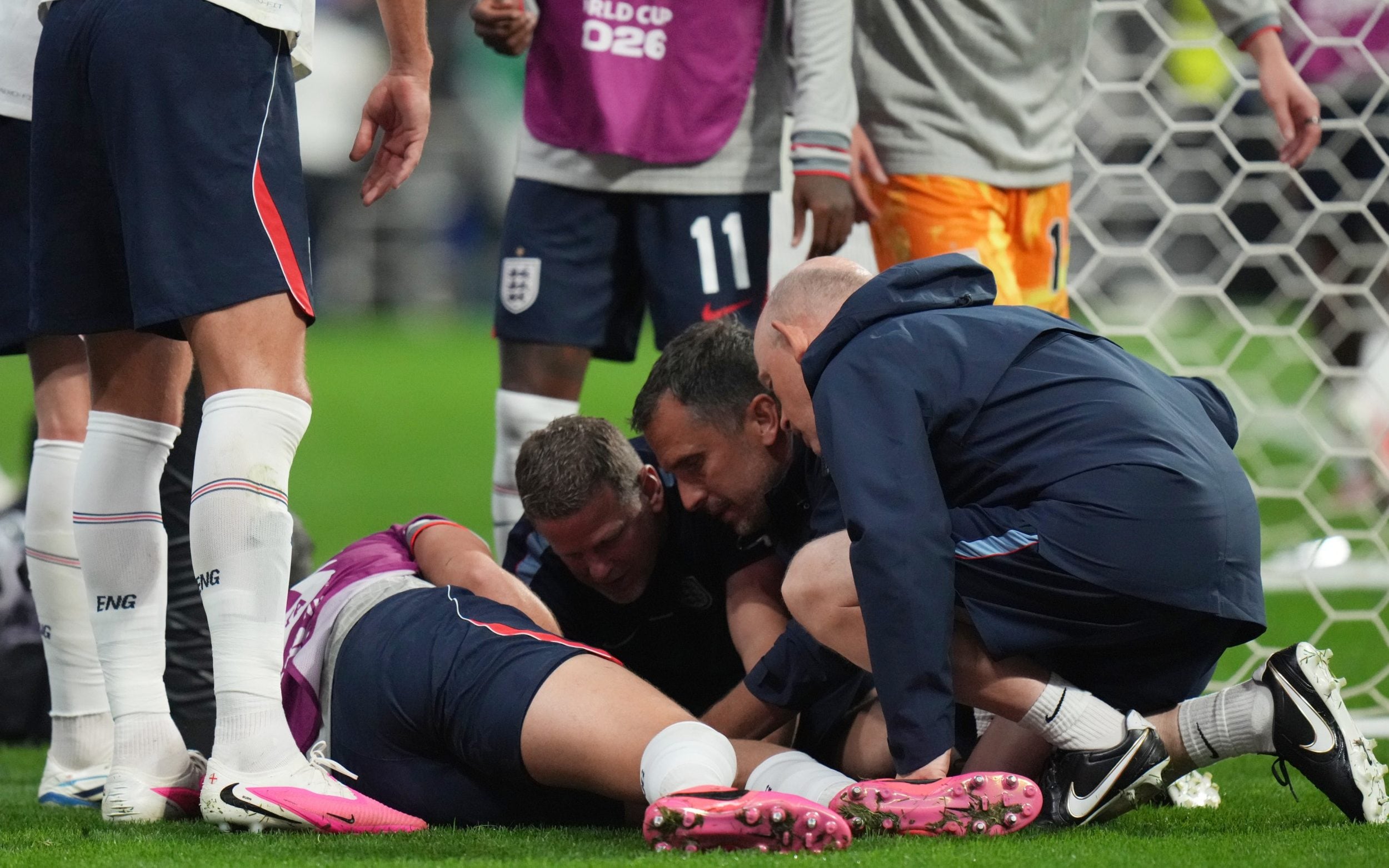 England's Jordan Henderson (14) is looked after by training staff following an arm injury