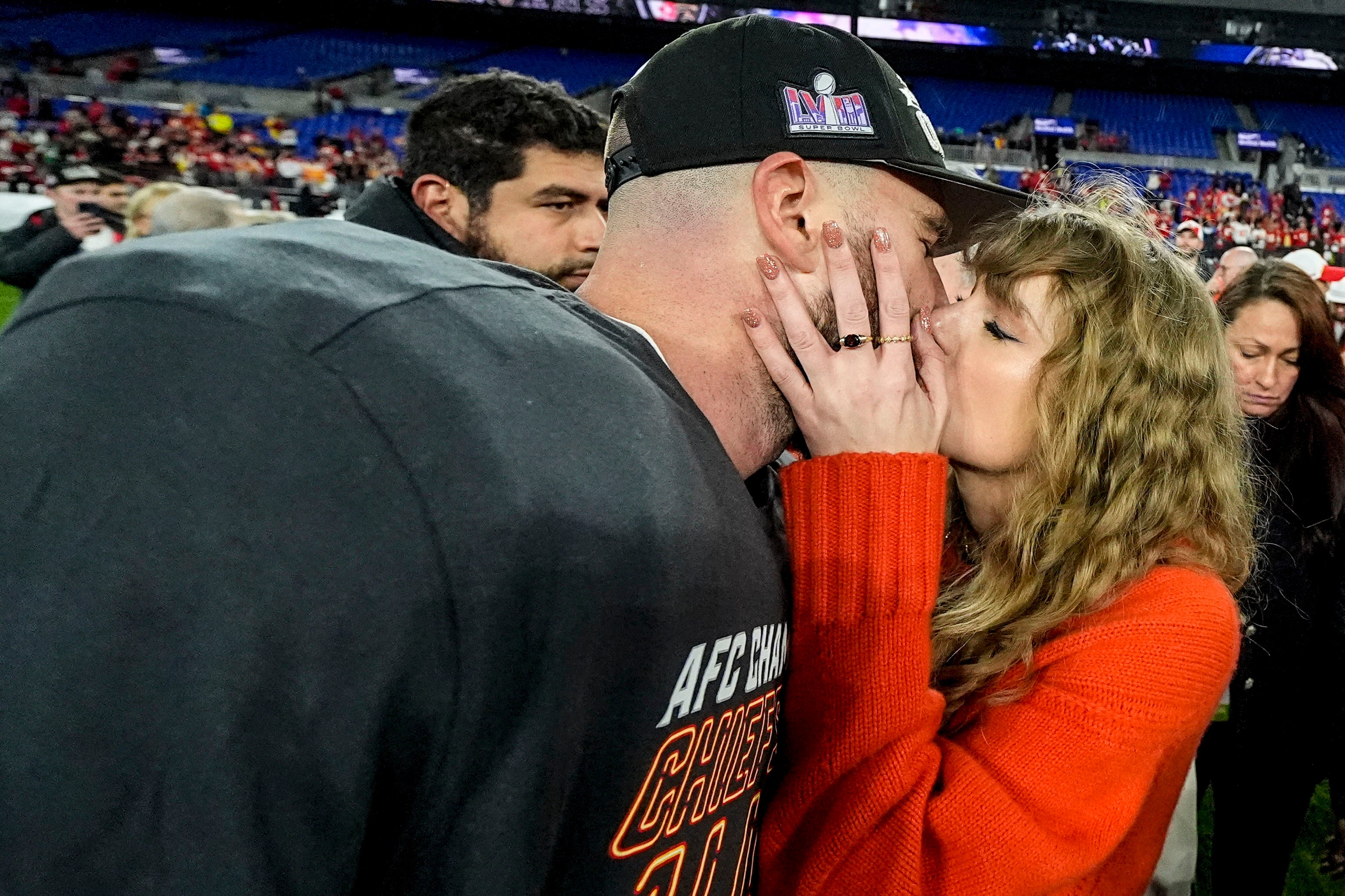 Travis Kelce and Taylor Swift kissing on the field