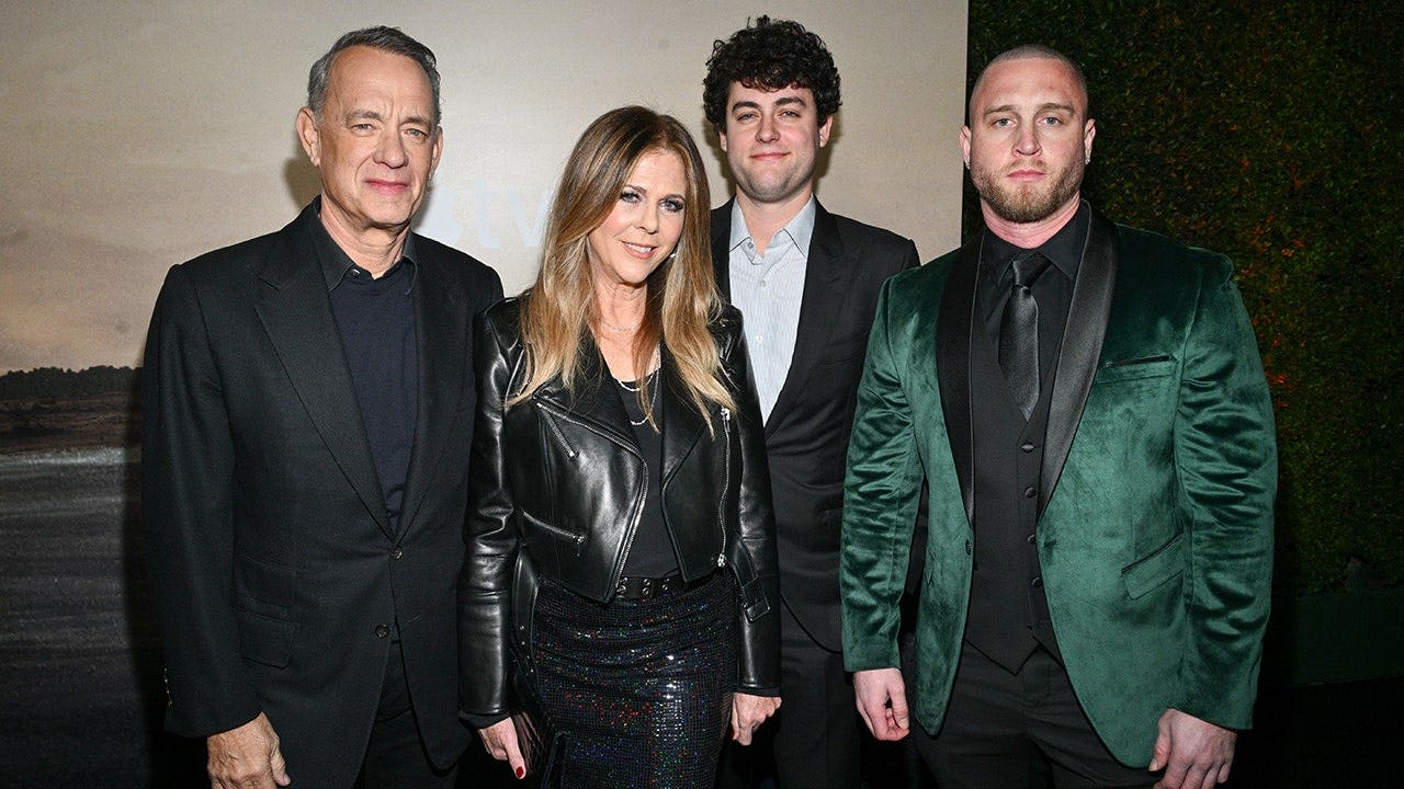 Tom Hanks and Rita Wilson standing with their sons Truman Hanks and Chet Hanks at a premiere event