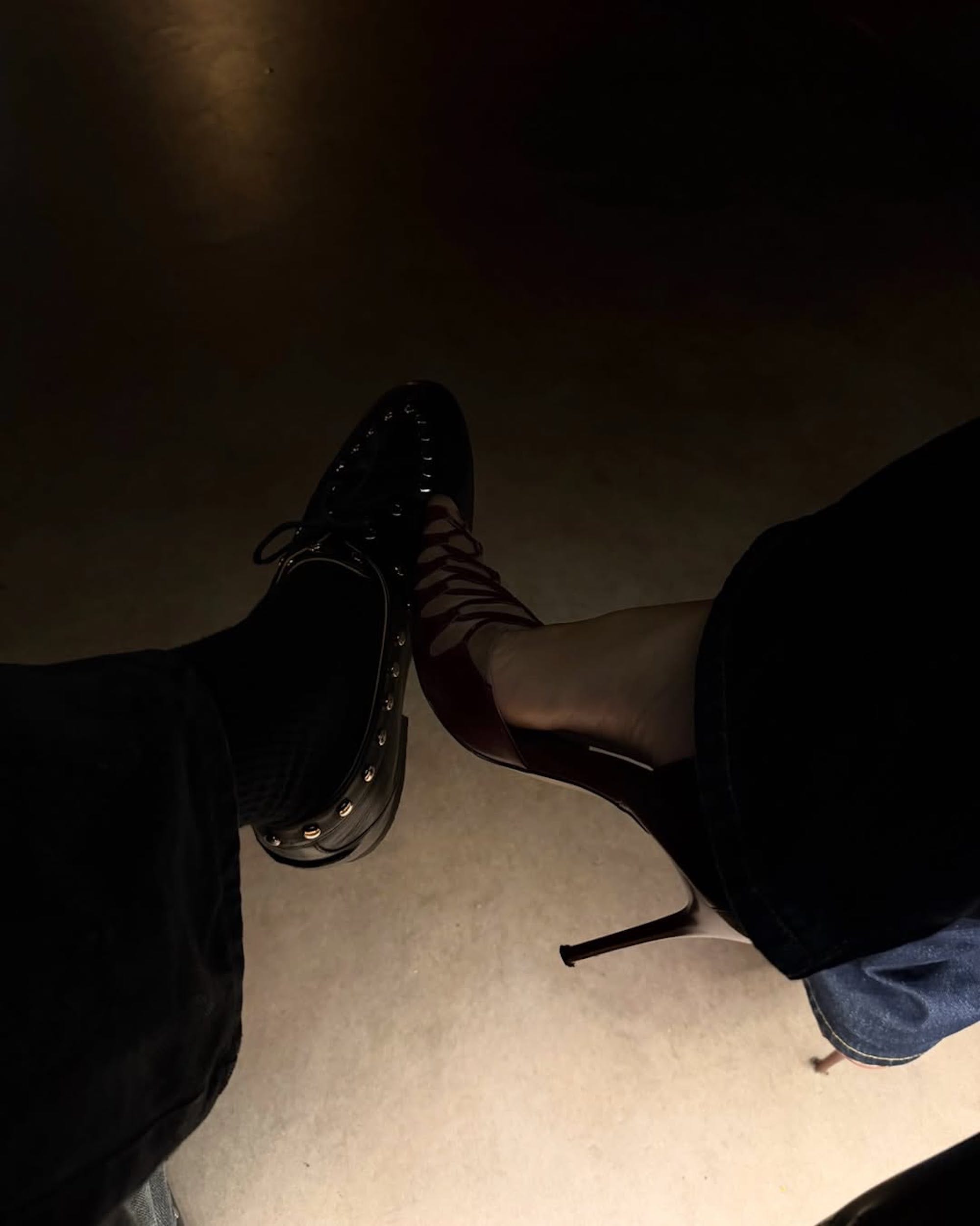 Contrast of two different shoe styles on separate feet.