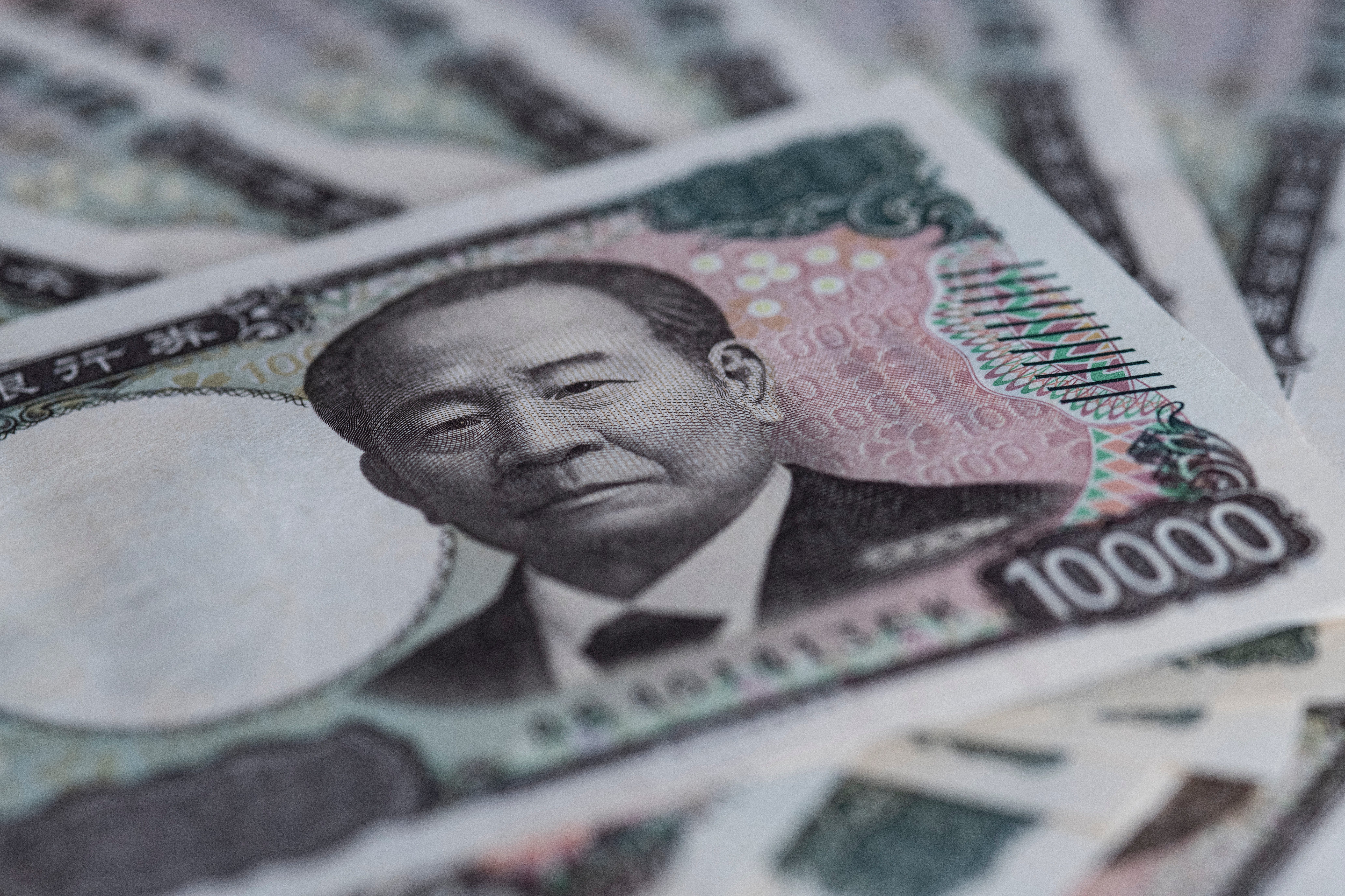 A stack of 10,000 yen notes photographed at an angle
