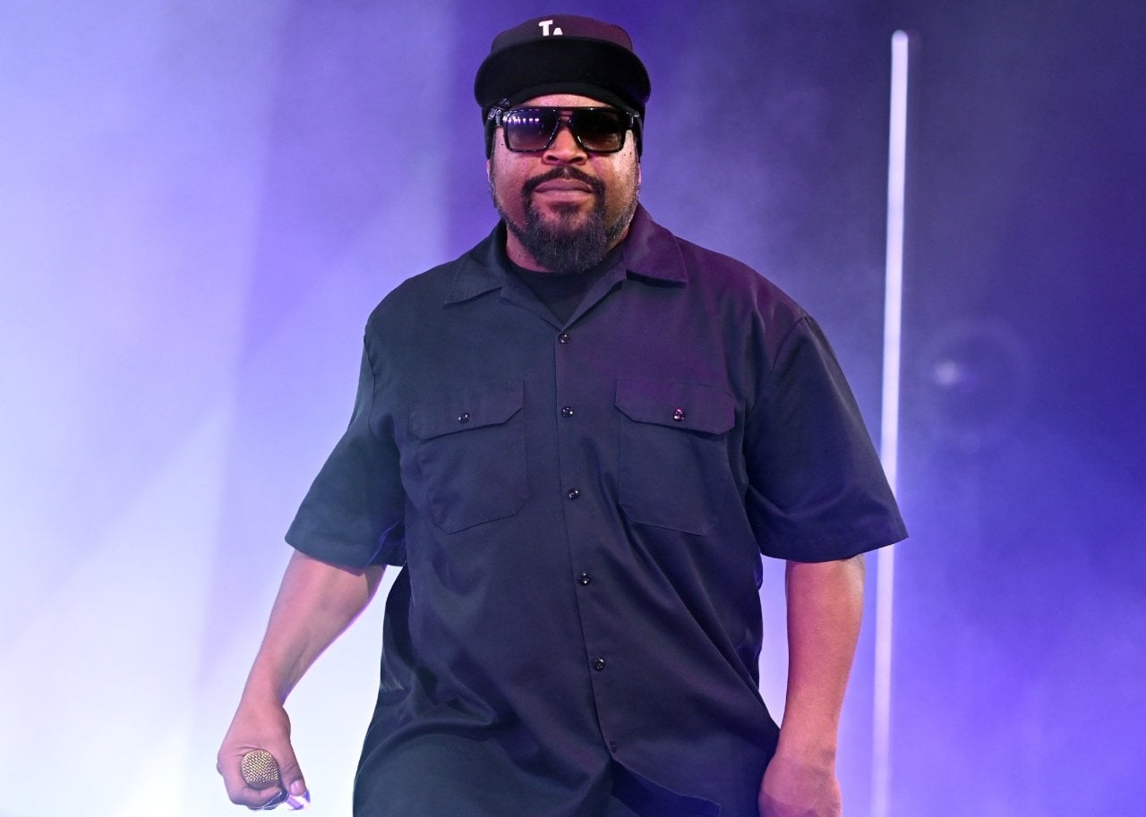 Ice Cube on stage in sunglasses and a black shirt. - 