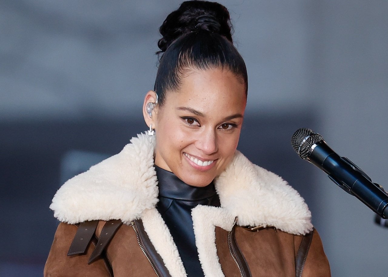 Alicia Keys in a brown bomber jacket. - 
