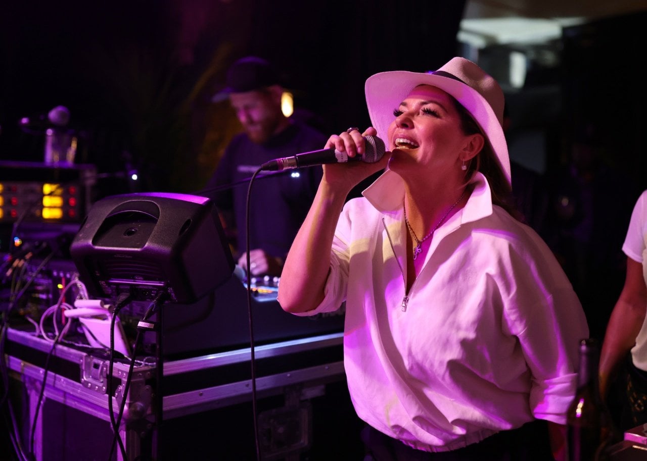 Shania Twain performs in a white panama hat and collared top. - 
