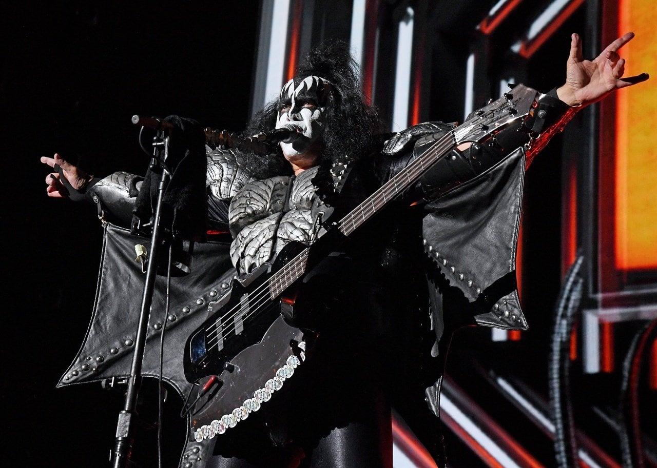 Gene Simmons performs as a member of the band Kiss in full black-and-white makeup and costume. - 