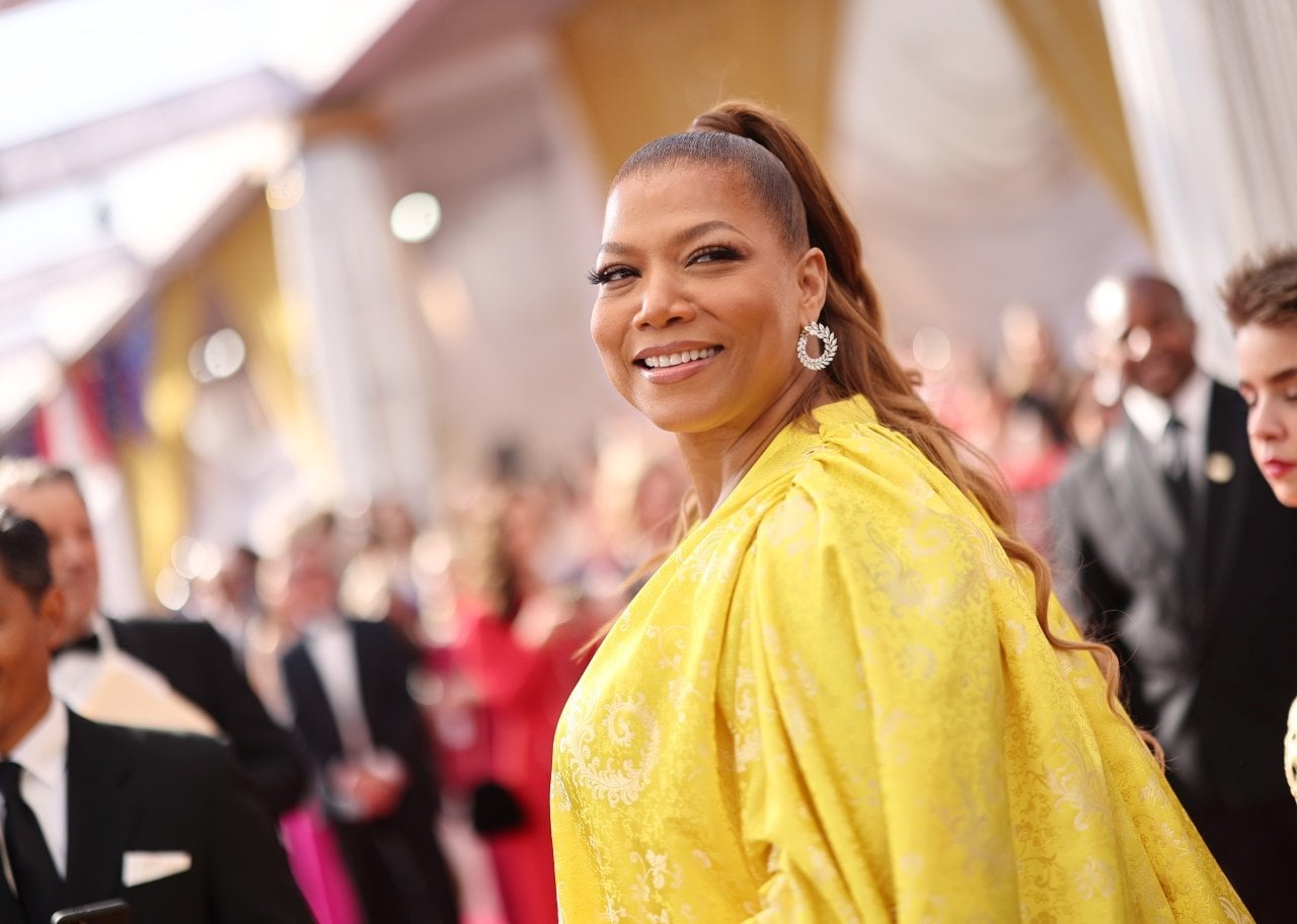 Queen Latifah poses in a yellow gown. - 