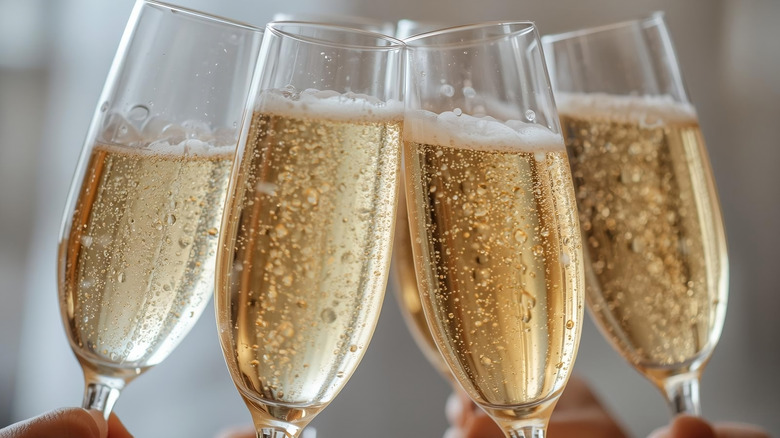 Clinking of glasses filled with champagne
