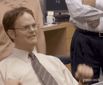 Dwight Schrute raising his arms up in celebration