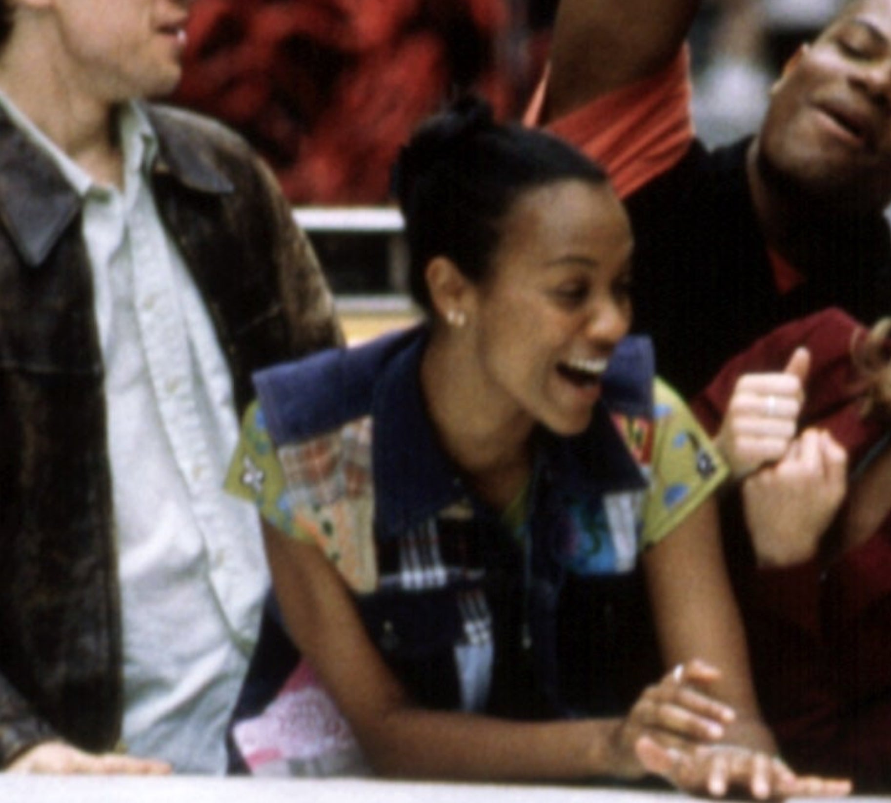 Young Zoe Saldana laughing and enjoying herself in a casual setting