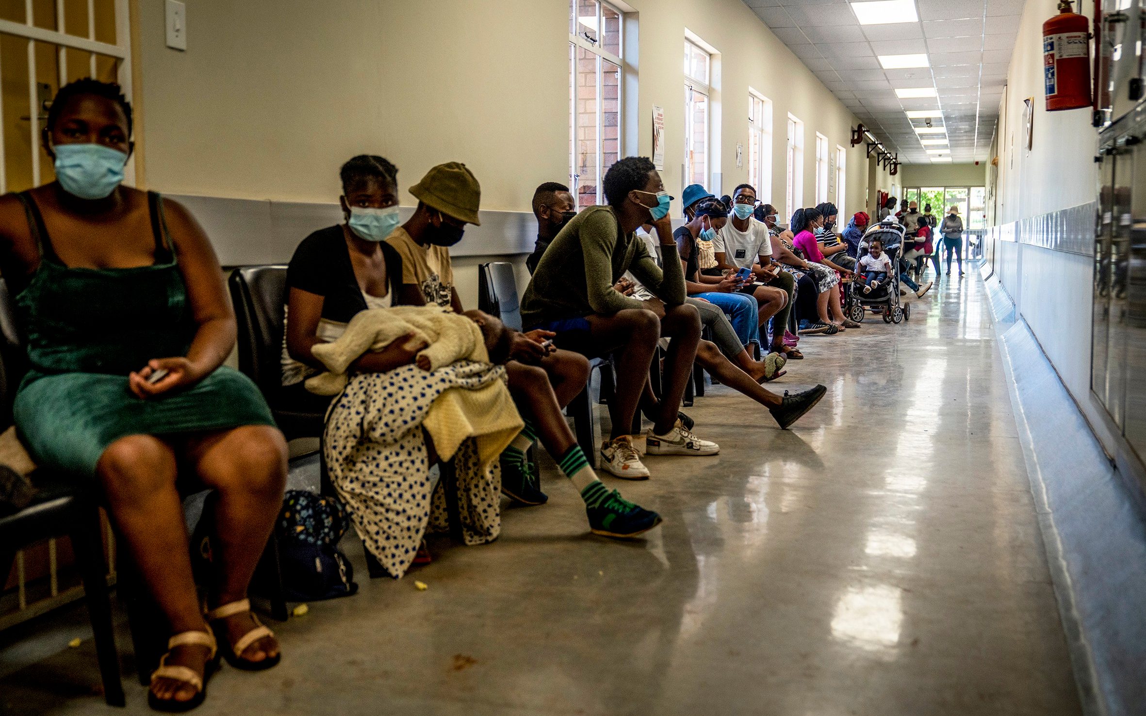 People queue to be vaccinated against COVID-19 at the Lenasia South Hospital, near Johannesburg