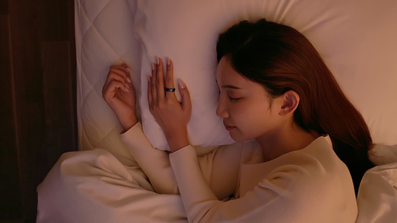 A woman sleeping while wearing an Oura Ring