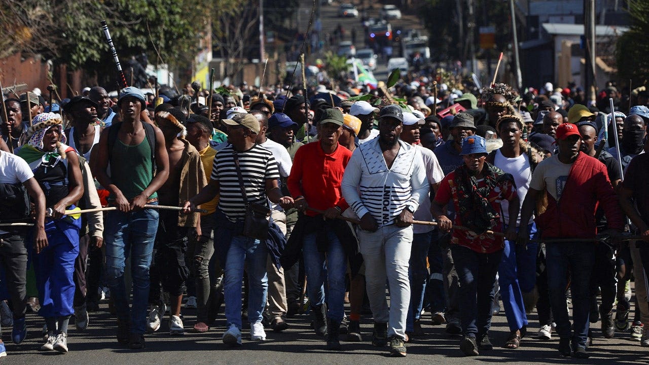 crowds of marchers walk through street