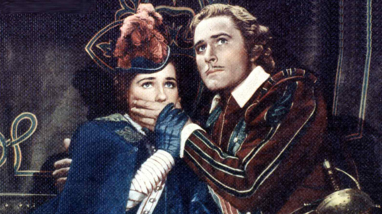 Geoffrey Thorpe holding a hand over Dona Maria's mouth in The Sea Hawk