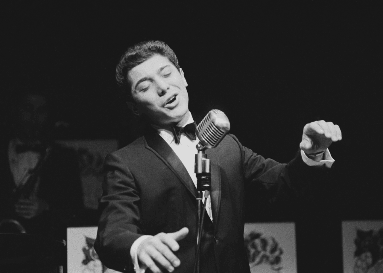 Paul Anka singing onstage. - 