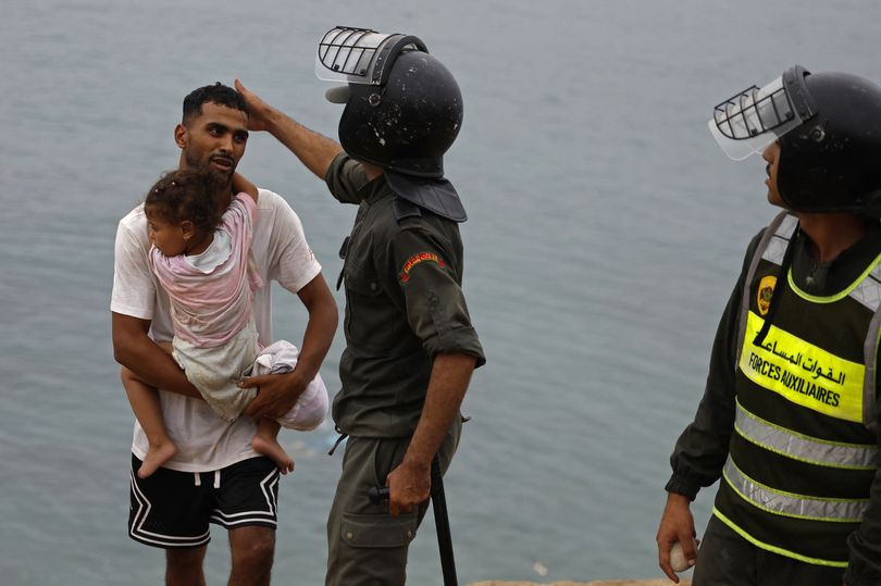 Woman's desperate bid for land clinging to child's inflatable as 60,000  migrants enter Ceuta in border crisis - AOL
