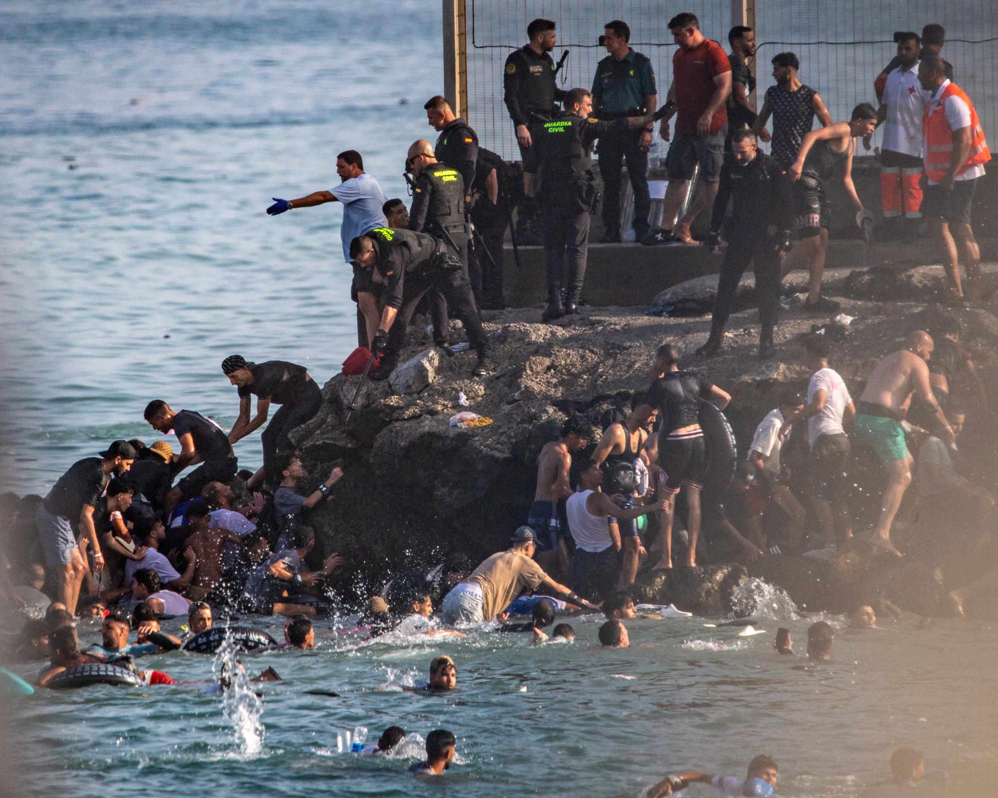 At least 57 people die as tens of thousands cross to Spanish enclave of Ceuta from Morocco