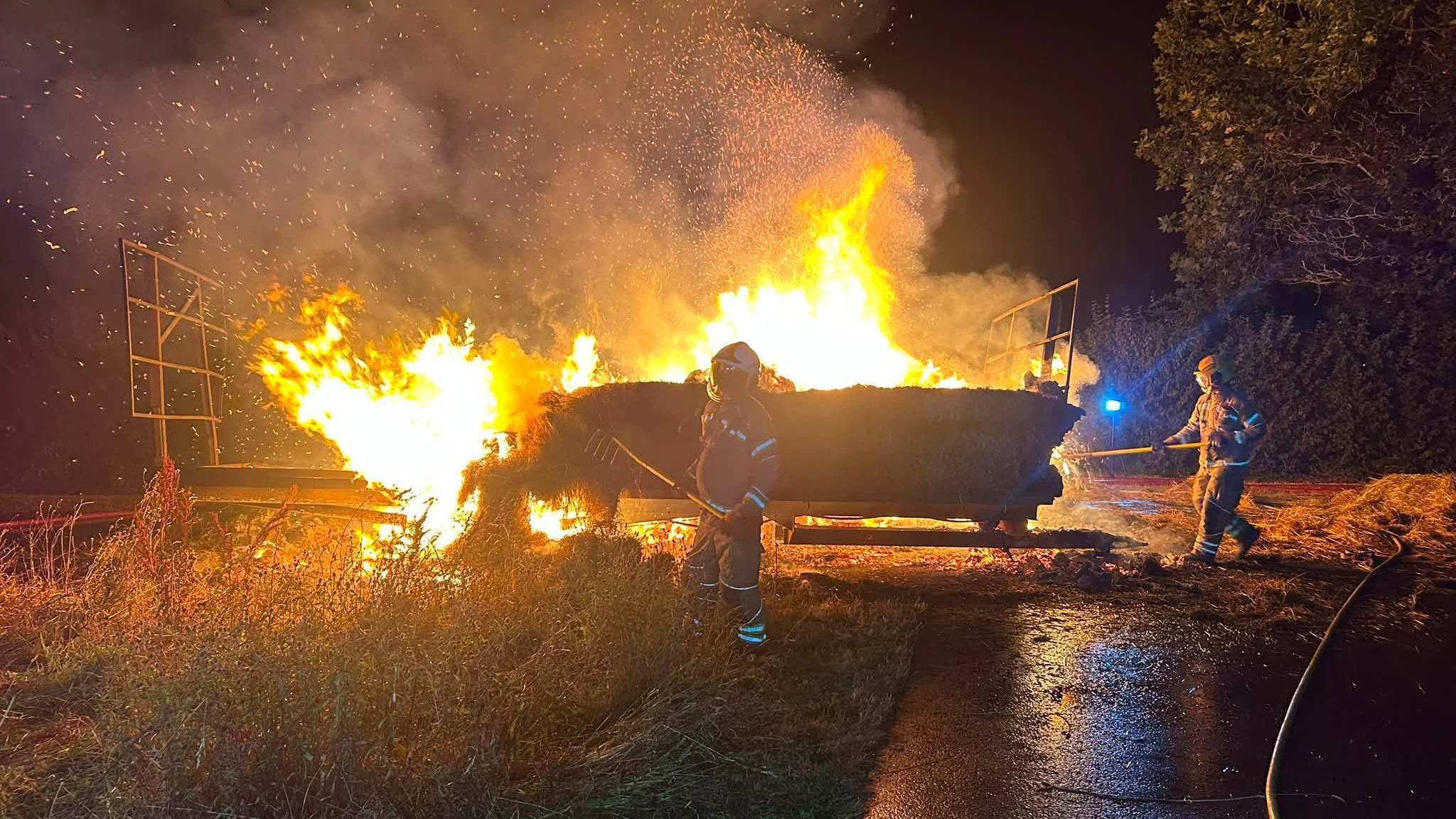 Fire crews and farmers battle trailer blaze