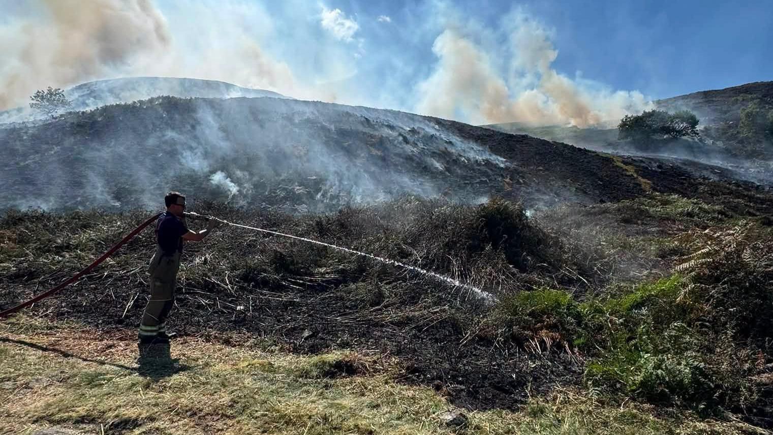 No visible flames as crews monitor wildfire hotspots