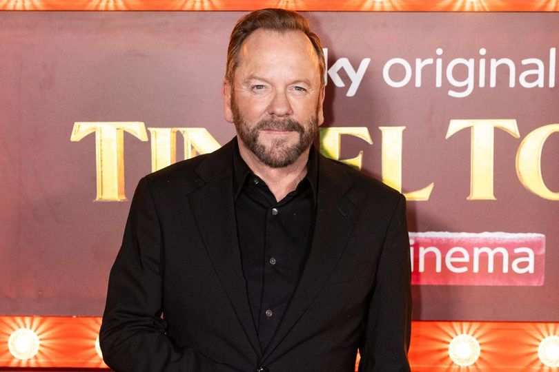 Bearded man wearing black suit