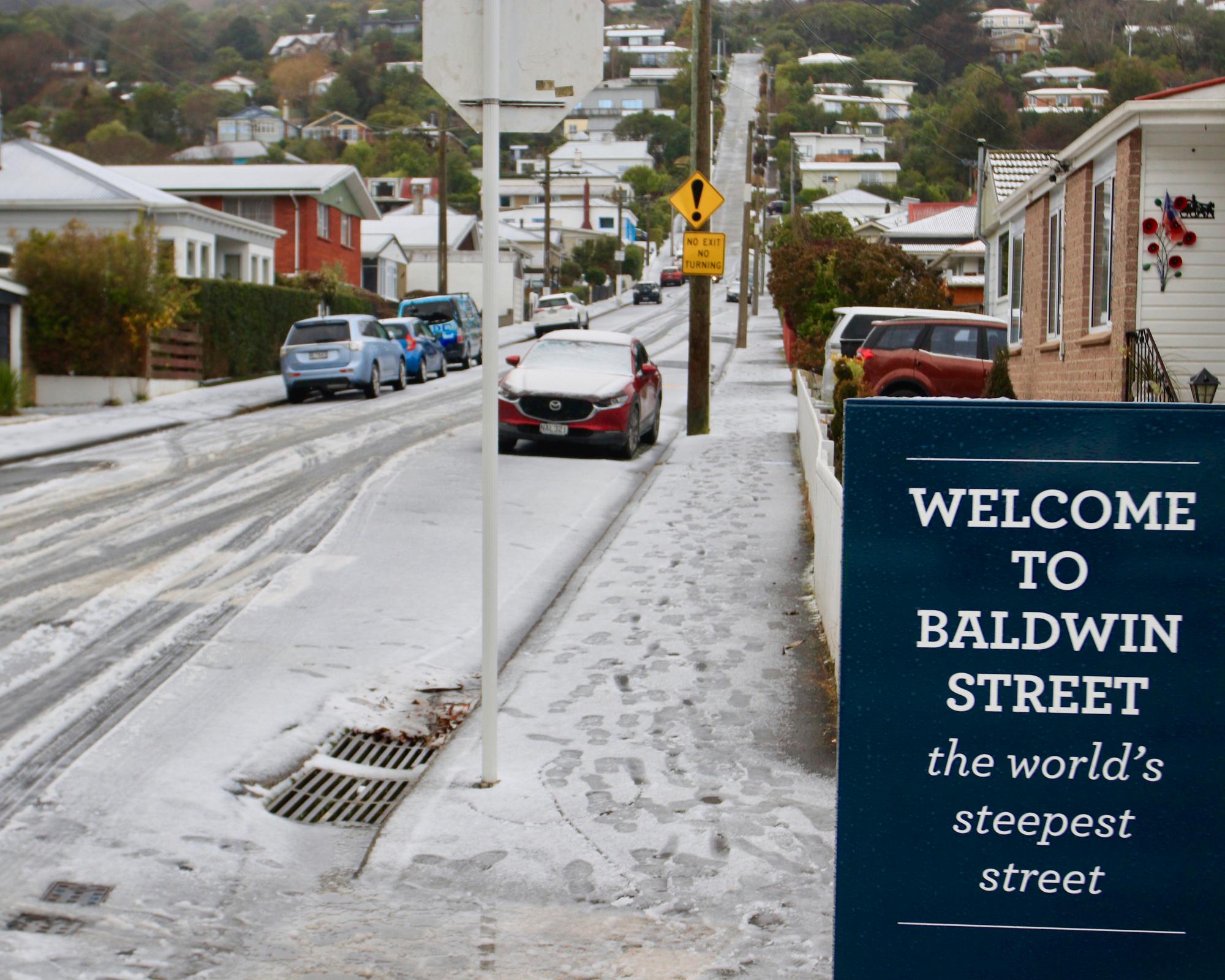 New Zealand capital delights in rare snowfall as southern city residents ski down world's steepest street