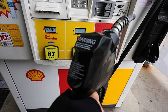 A black fuel pump is being operated