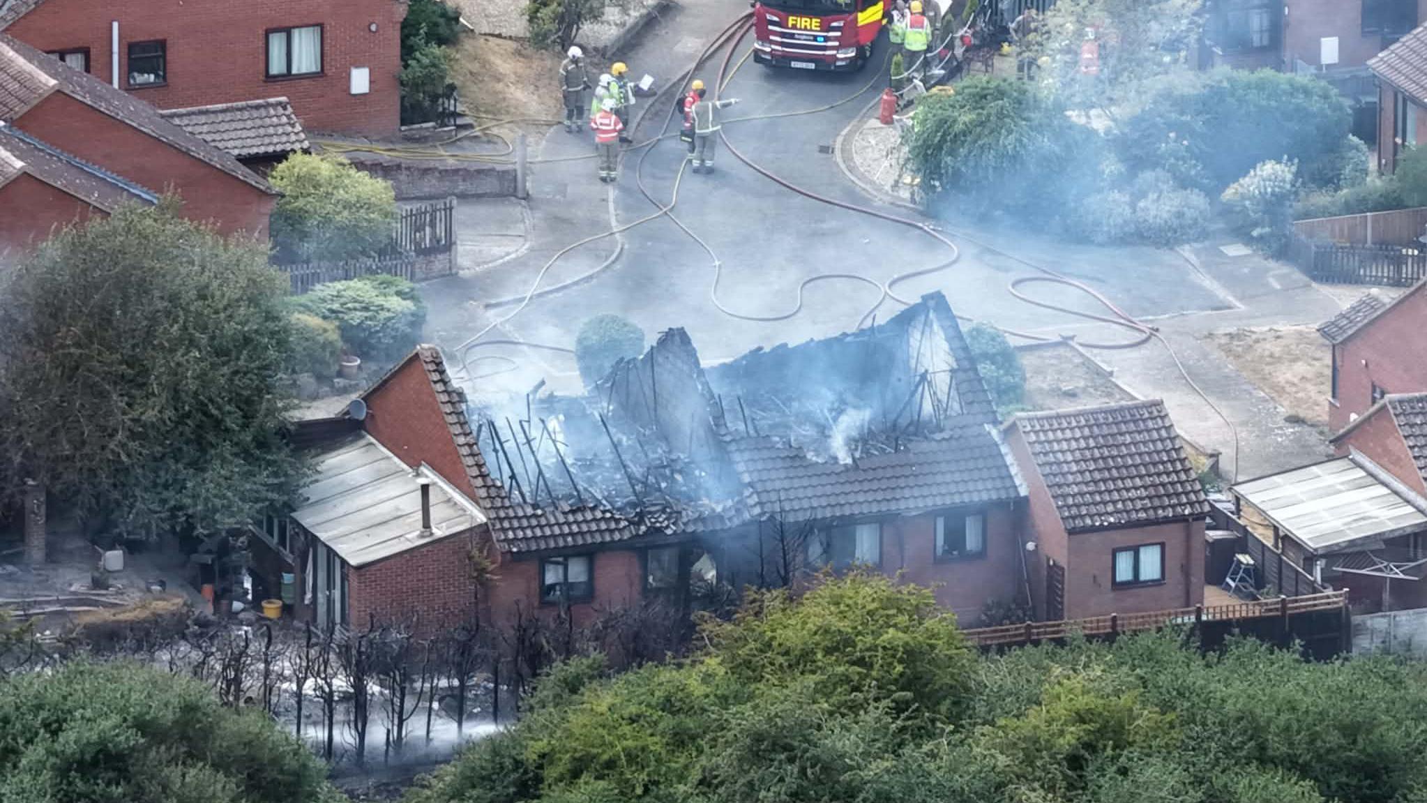 Homes badly damaged after wildfire spreads to street