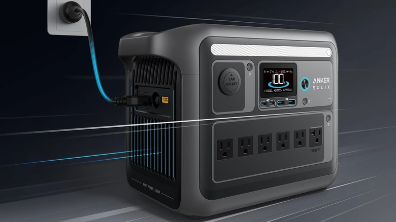 The Anker Solix C1000 Portable Power Station in a promo shot connected to a wall outlet