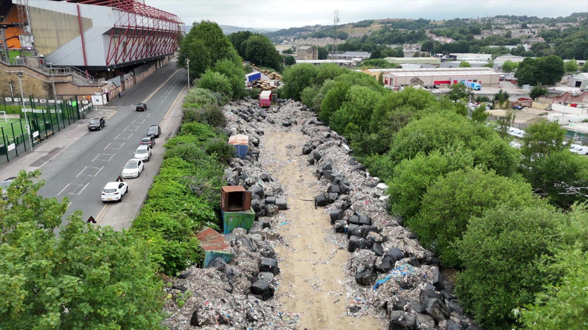 'We live and work next to a huge illegal waste dump'