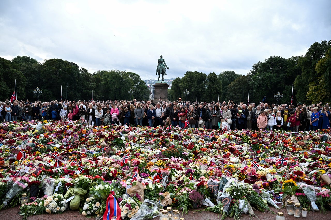 People gather to pay their respects outside the Royal Palace, following the death of Norway's King Harald (Reuters)