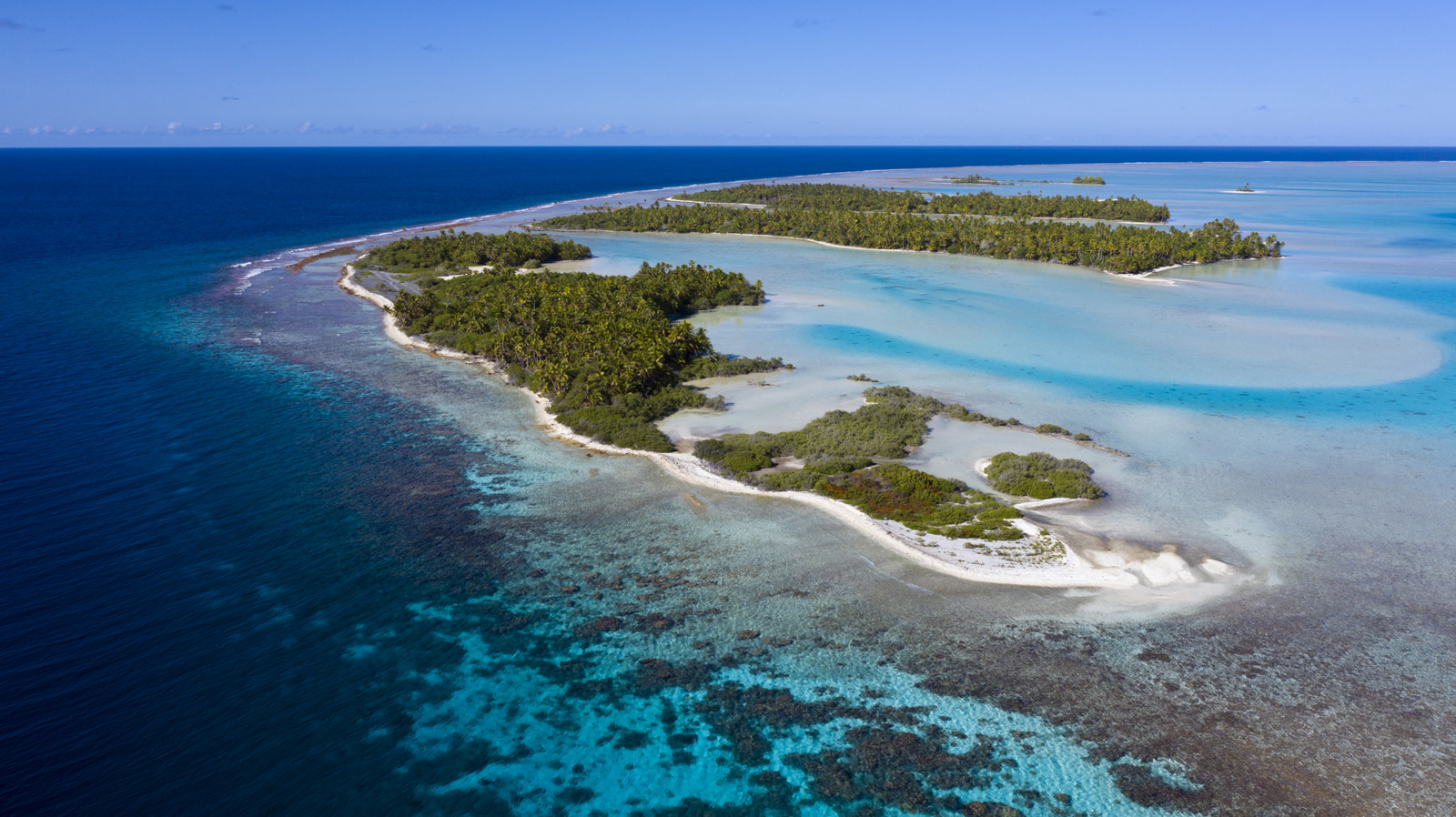 Tranquil Lagoons, Vibrant Marine Life, And Pink Sands Create Magic At This Polynesian Island Paradise