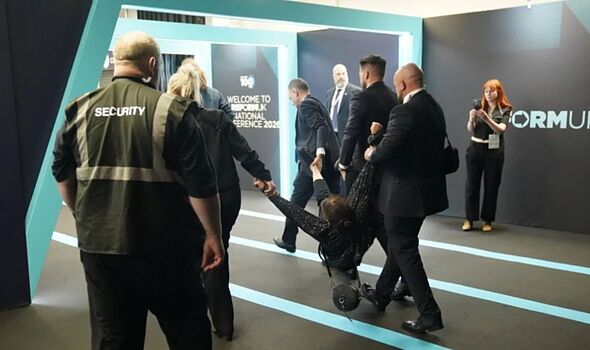 Police issue update as Nigel Farage heckler 'hit with walking stick' at Reform  conference - AOL