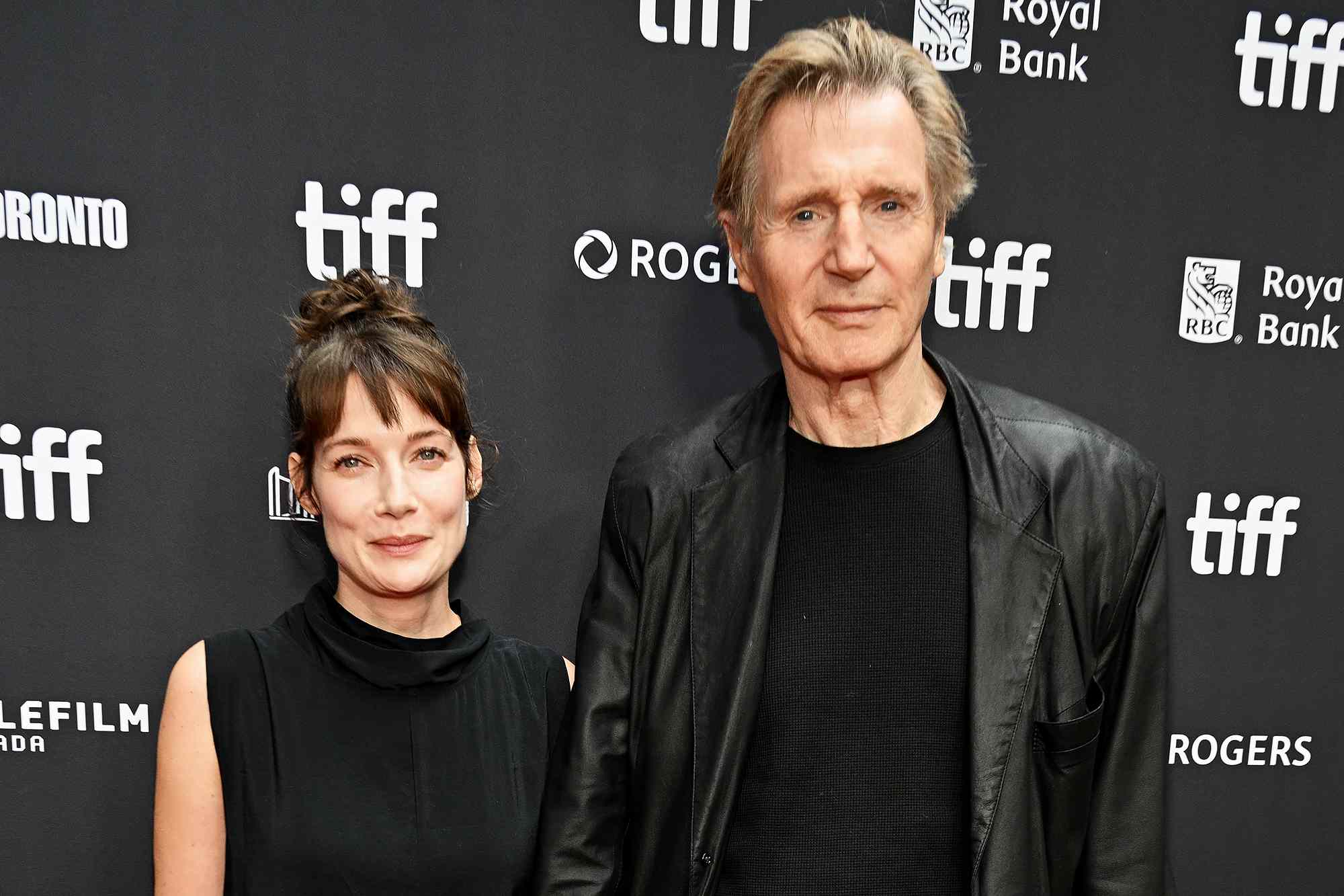 Liam Neeson holds hands with Stella Stocker on TIFF red carpet