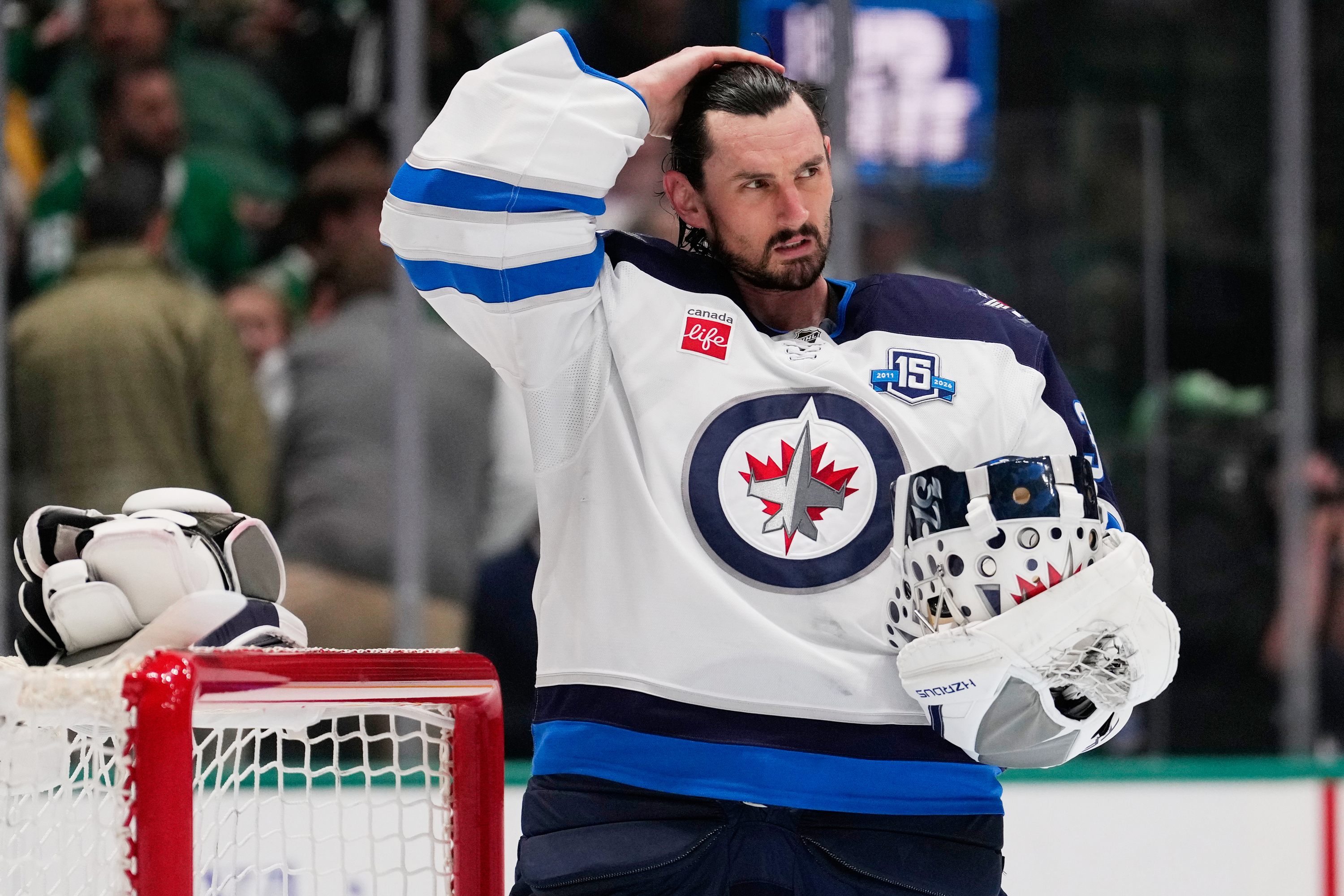 Connor Hellebuyck in a white Winnipeg Jets jersey in 2026