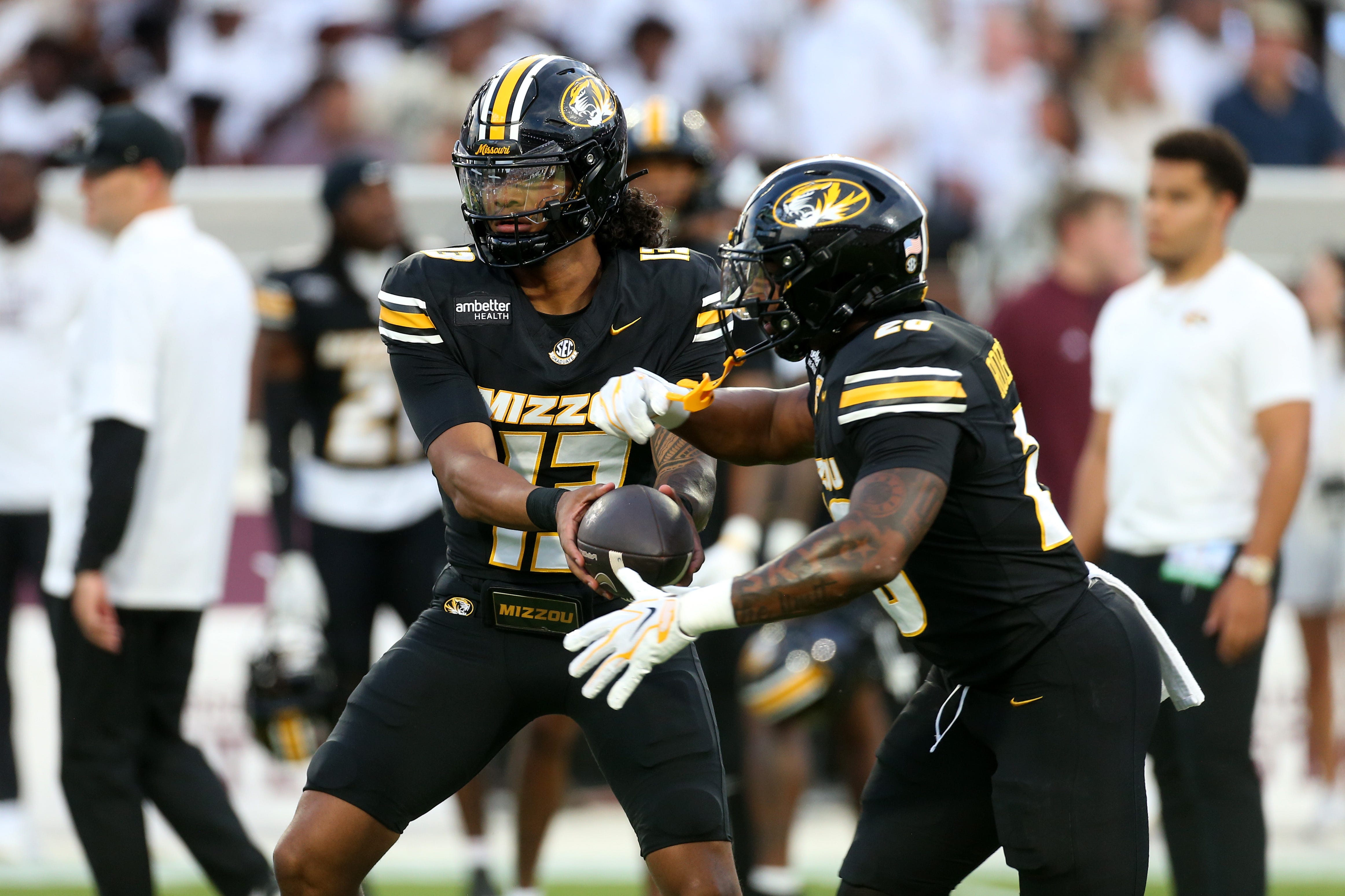 Missouri quarterback Austin Simmons handing the football to running back Jamal Roberts during warmups before the September 26 2026 Mississippi State game