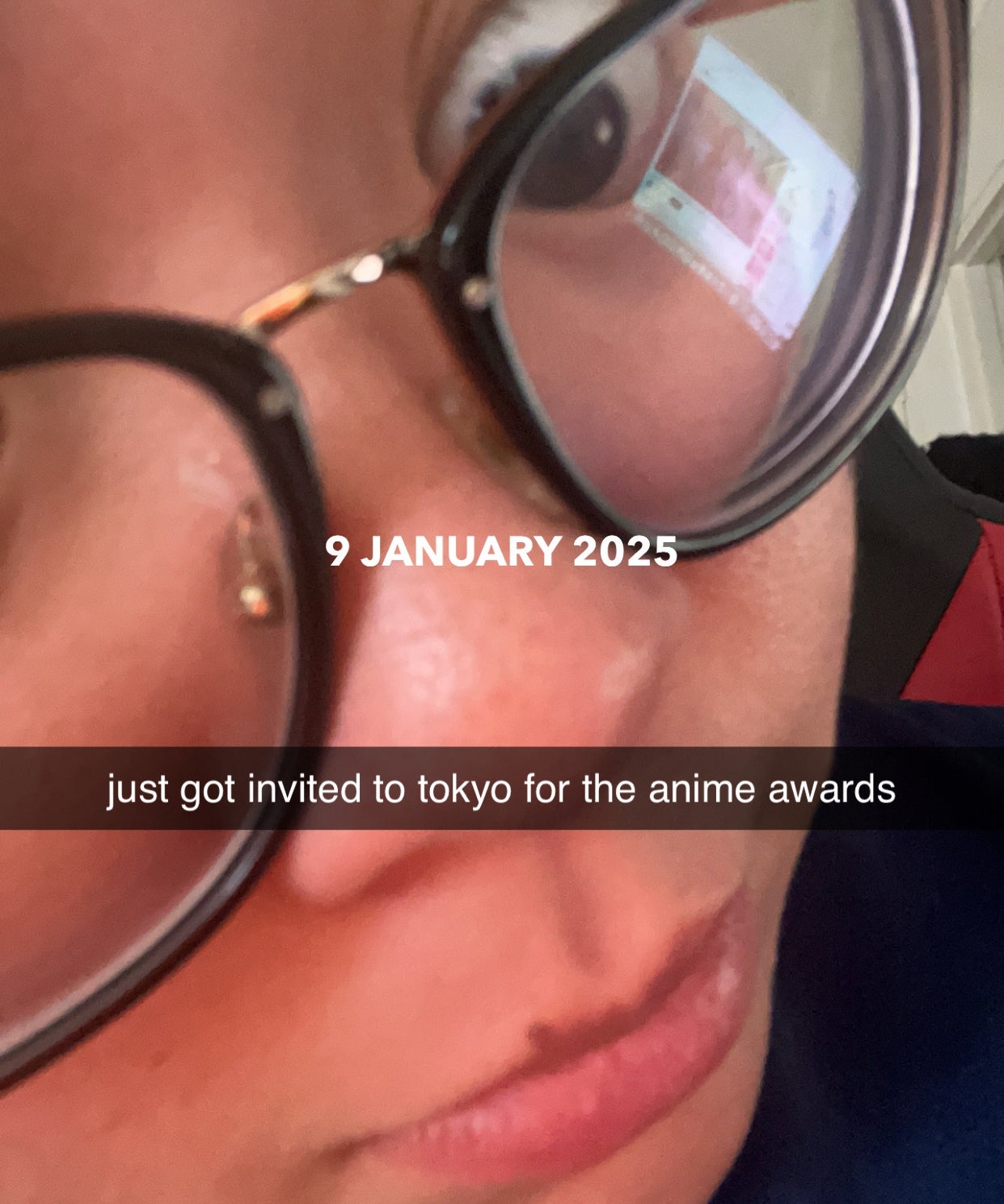Close-up of a person wearing glasses, text overlay says: "9 January 2025, just got invited to Tokyo for the Anime Awards."