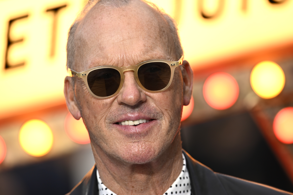 Michael Keaton wearing light-colored sunglasses and a polka-dot shirt.