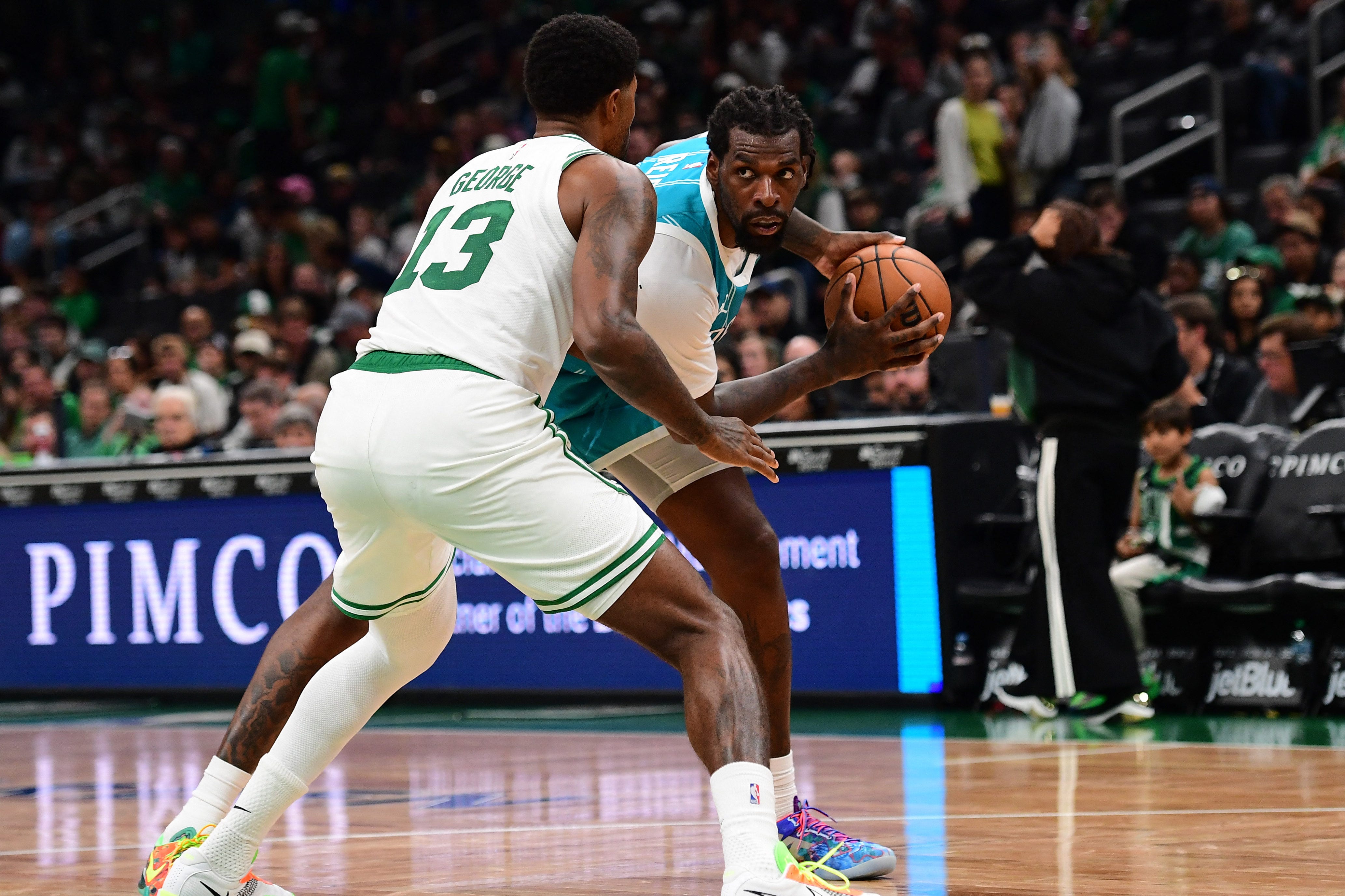 Oct 14, 2026; Boston, Massachusetts, USA;  Charlotte Hornets forward Royce O'Neale (00) controls the ball while Boston Celtics forward Paul George (13) defends during the second half at TD Garden. Mandatory Credit: Bob DeChiara-Imagn Images