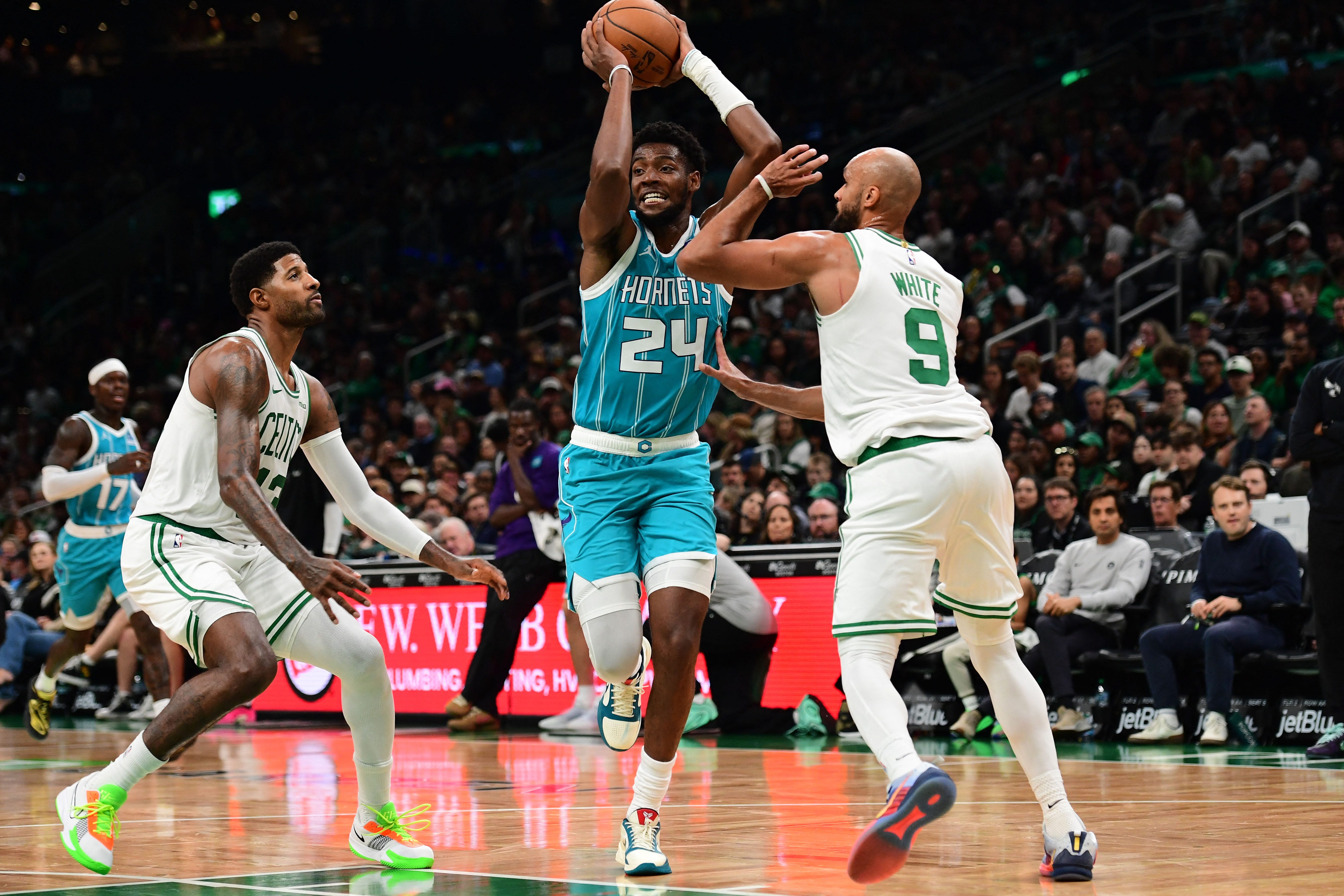 Oct 14, 2026; Boston, Massachusetts, USA;  Charlotte Hornets forward Brandon Miller (24) controls the ball while Boston Celtics guard Derrick White (9) defends during the second half at TD Garden. Mandatory Credit: Bob DeChiara-Imagn Images