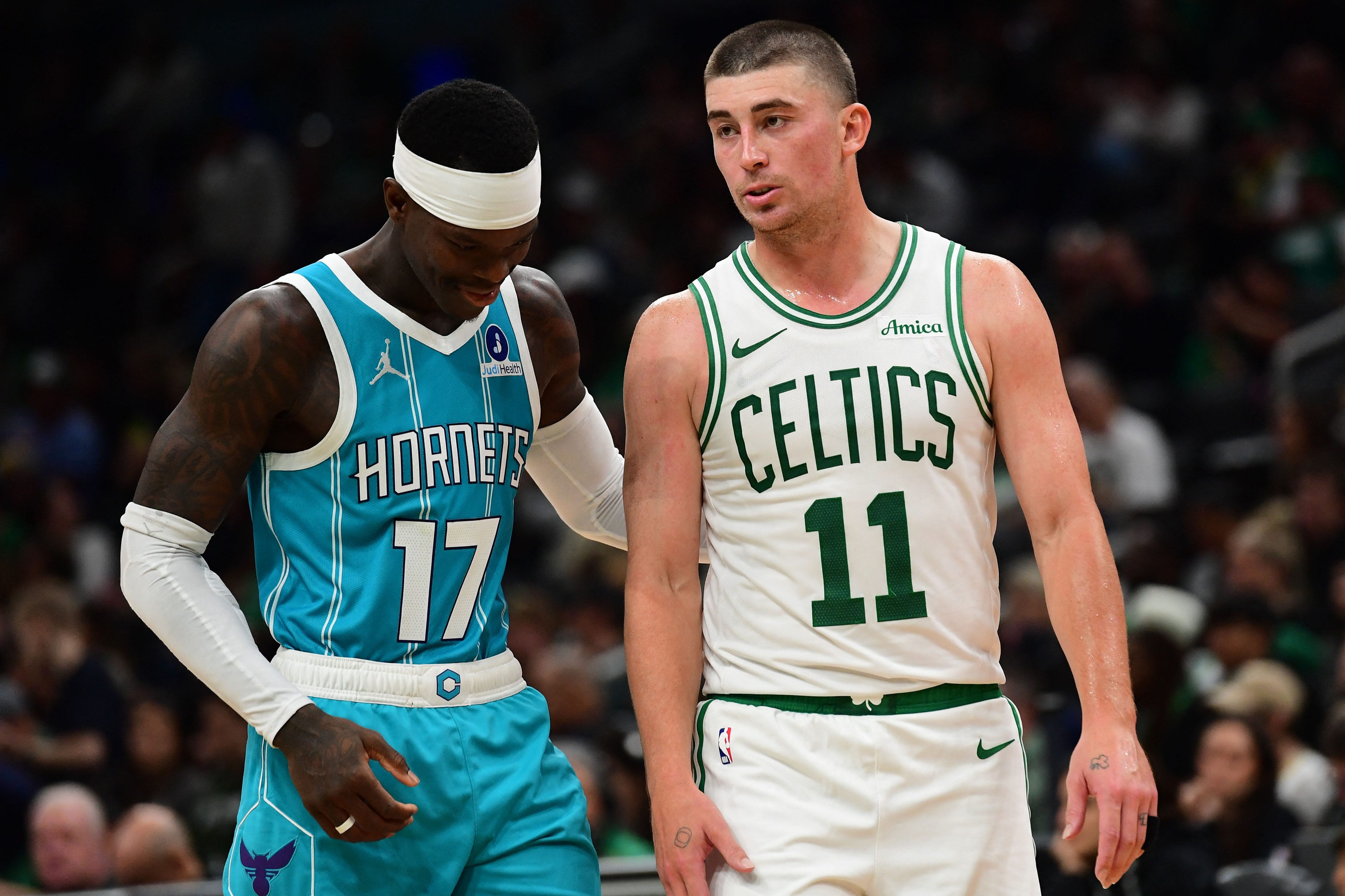 Oct 14, 2026; Boston, Massachusetts, USA;  Charlotte Hornets guard Dennis Schroder (17) talks with Boston Celtics guard Payton Pritchard (11) during the second half at TD Garden. Mandatory Credit: Bob DeChiara-Imagn Images