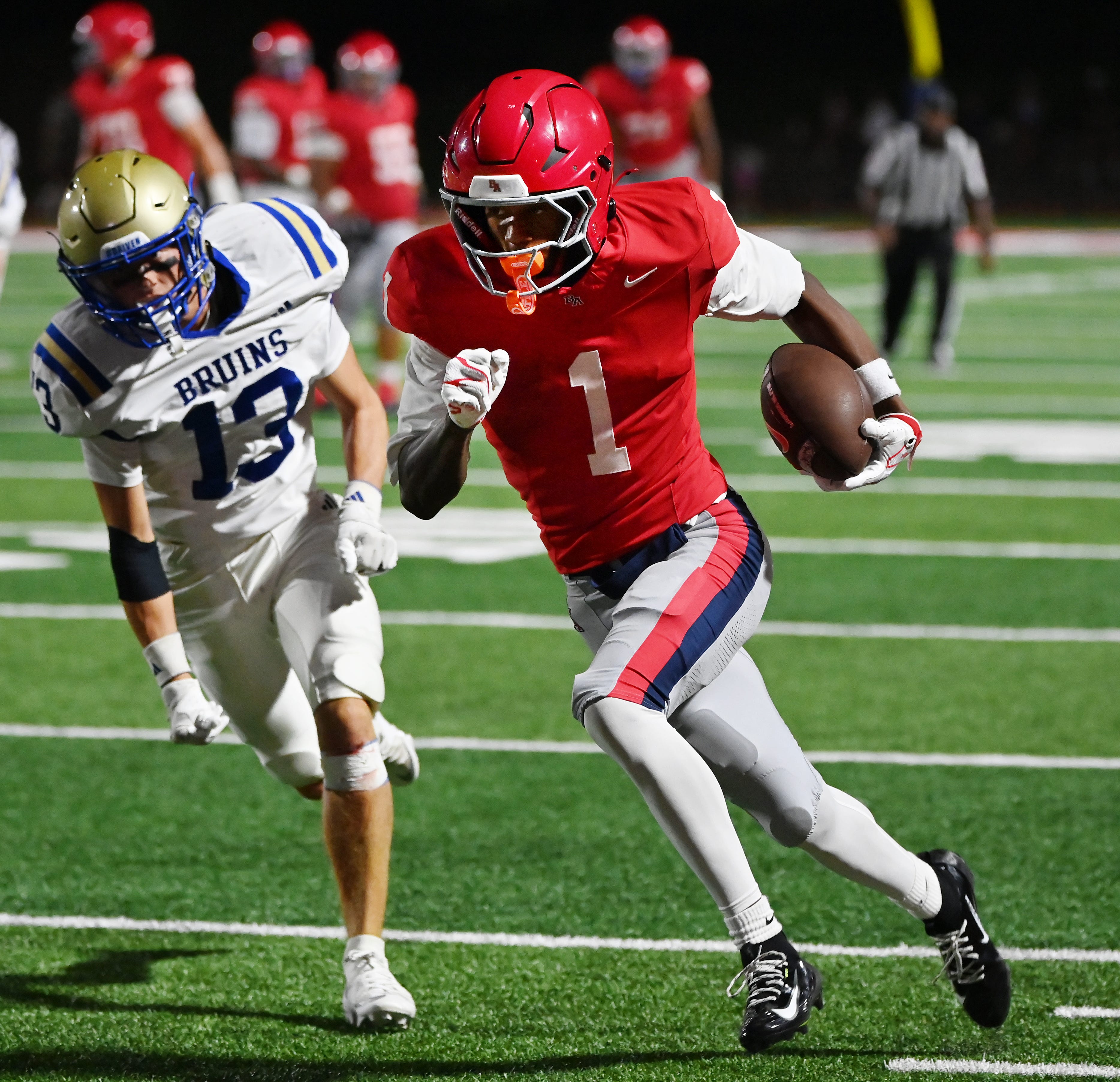 Brentwood Academy's Kesean Bowman (1) runs past Brentwood's Brodie Peace (13) during a TSSAA high school football game at Brentwood Academy on Friday, Aug. 28, 2026, in Brentwood, Tenn.