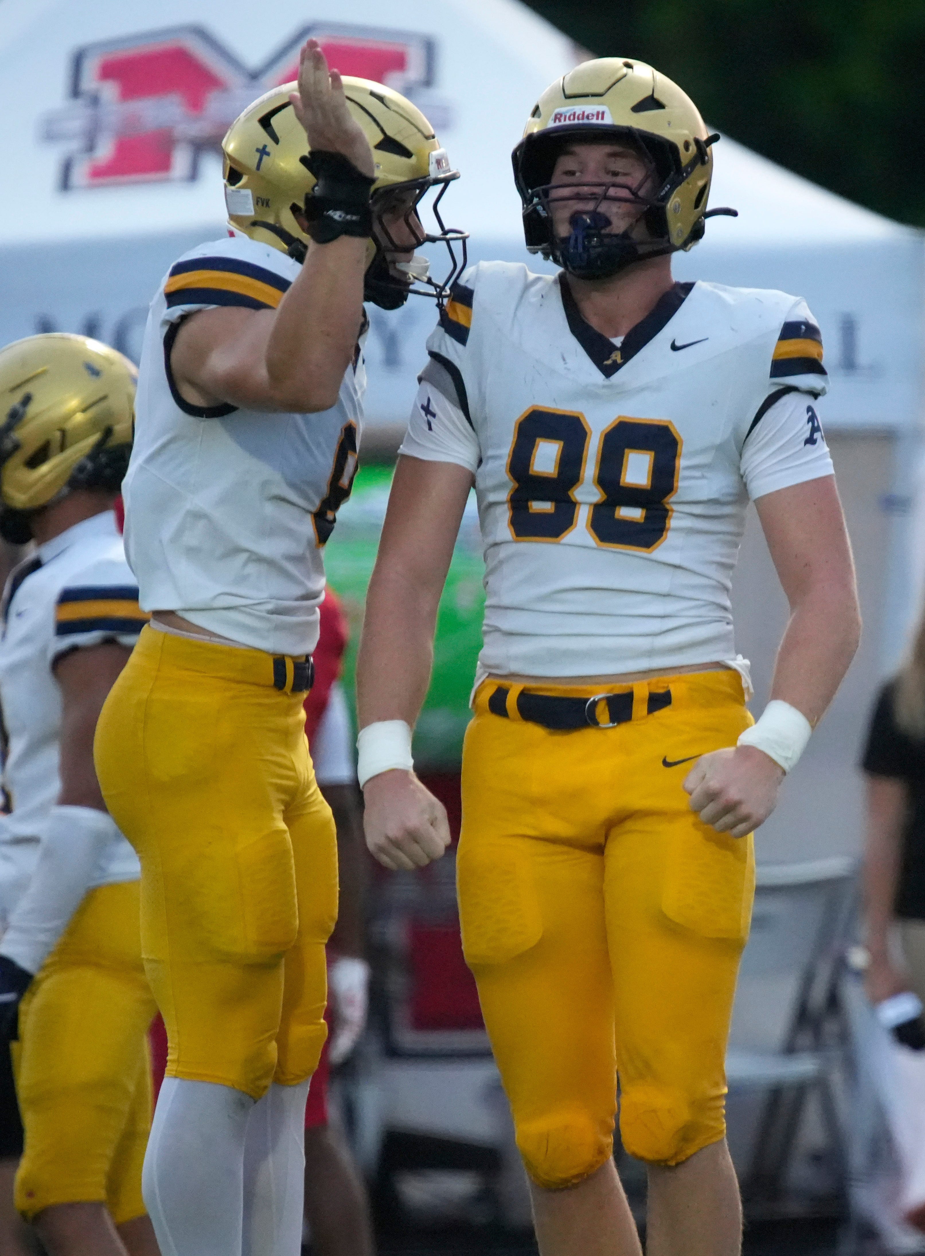 Aquinas defensive lineman Wyatt Smith (#88) celebrates a tackle with a teammate. The Cardinal Mooney Catholic High School Cougars hosted the St. Thomas Aquinas High School Raiders in their first football game of the season Friday, Aug. 14, 2026 in Sarasota.